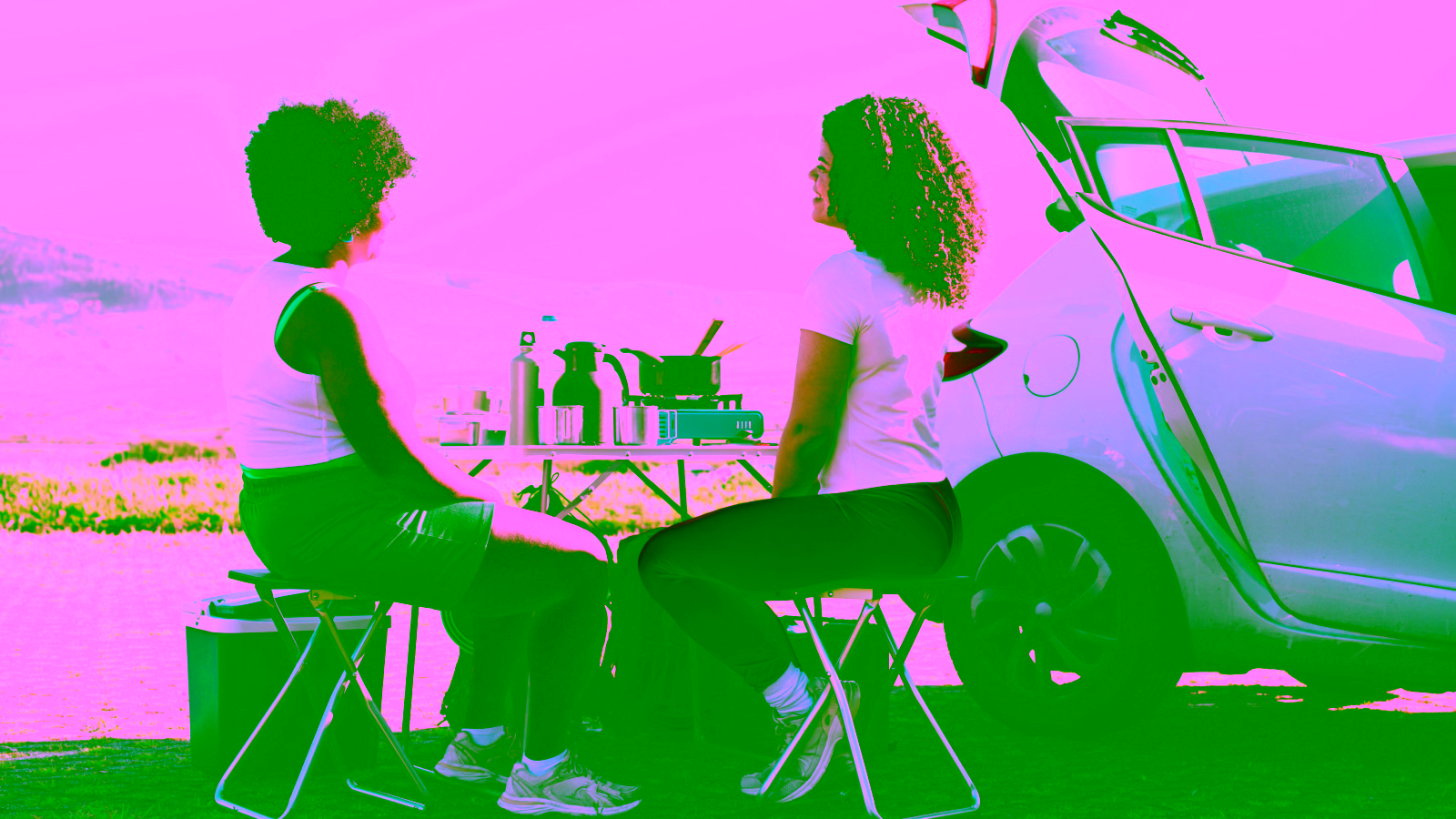 Two people camping by car