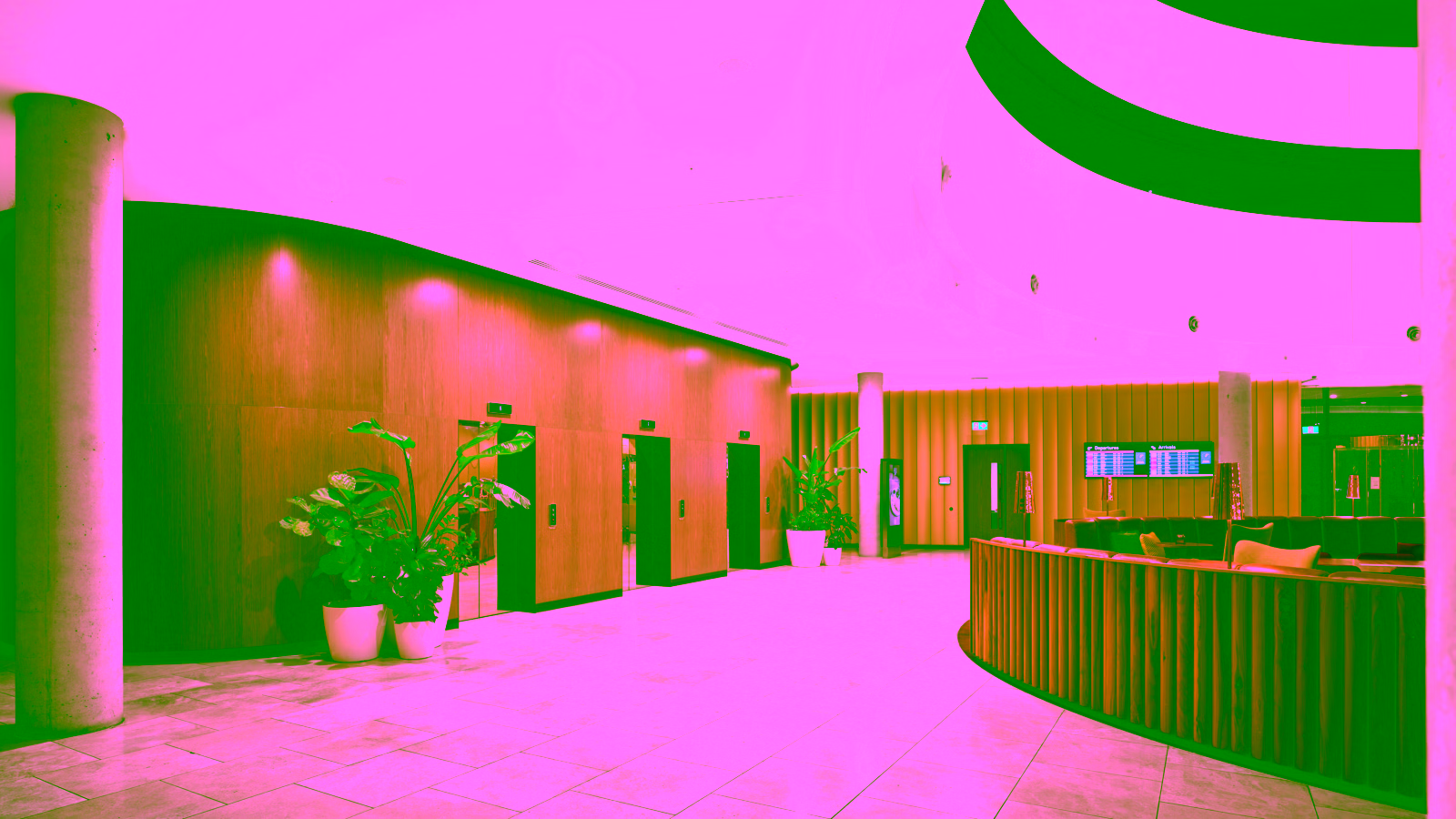 Modern hotel lobby with curved ceiling and wood paneling