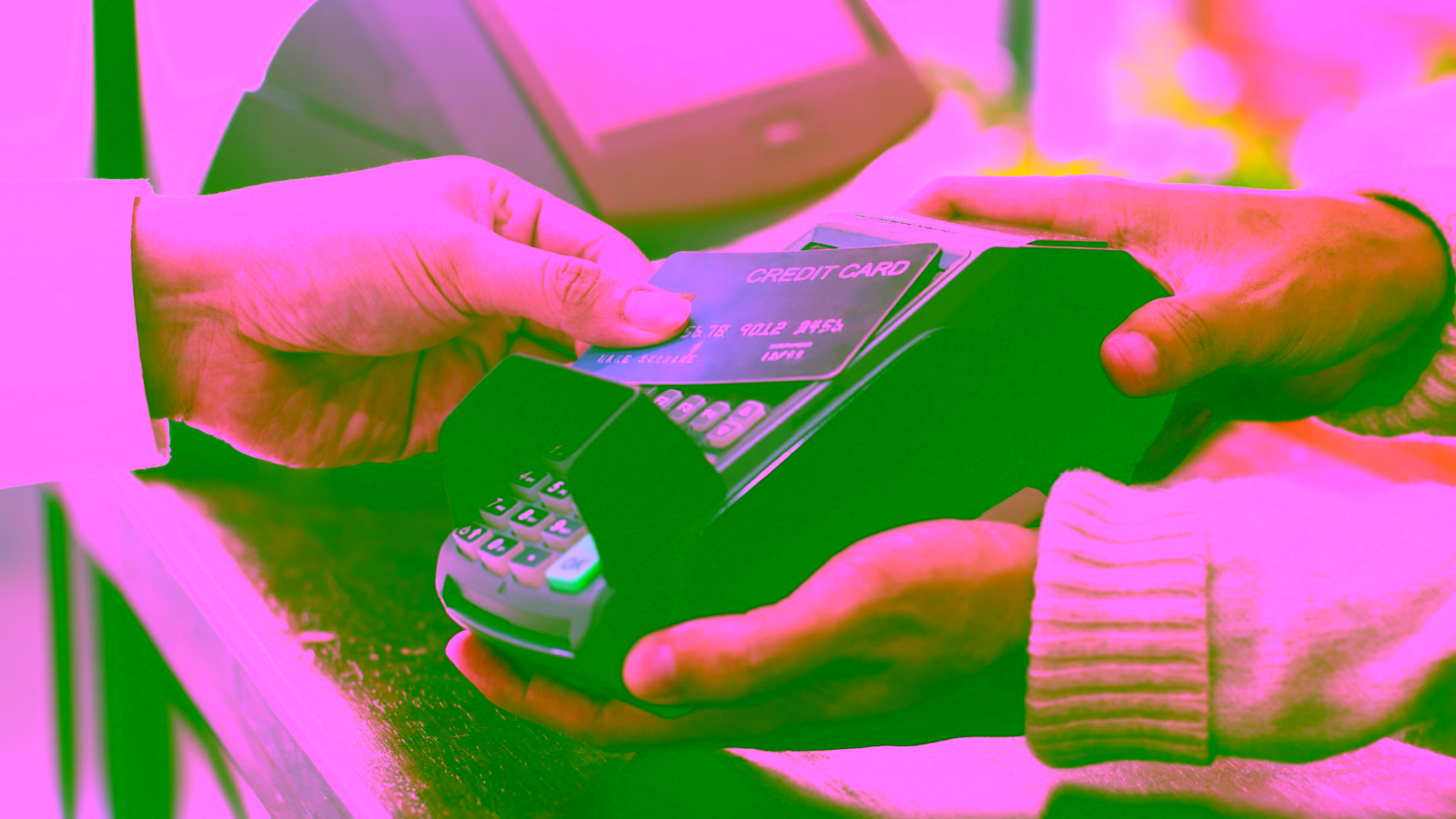 Person using credit card at payment terminal