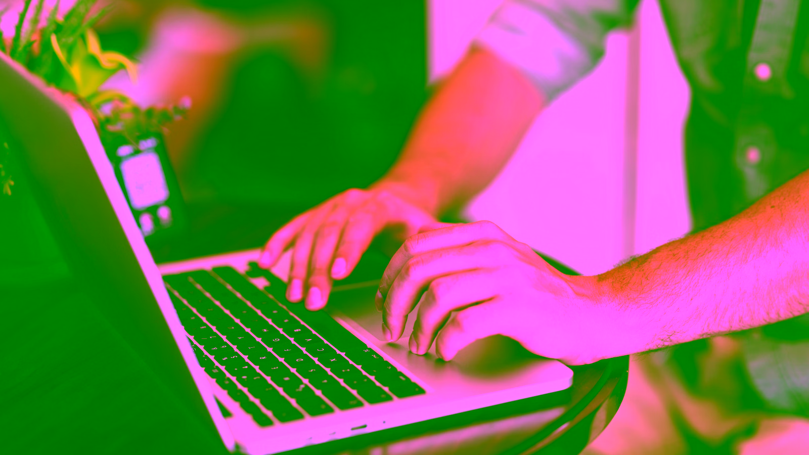 Person typing on laptop at desk