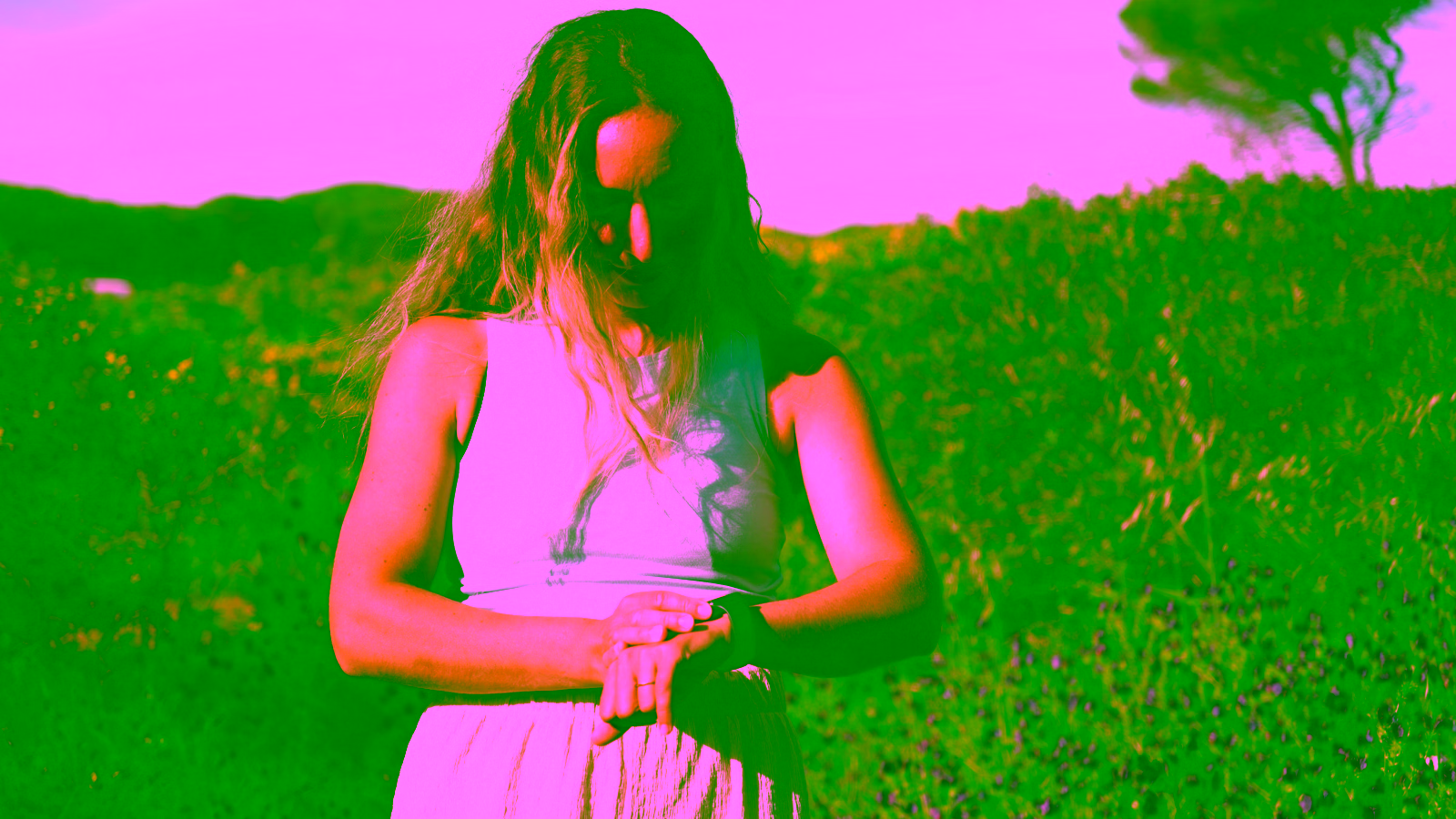 Woman checking fitness tracker on wrist outdoors