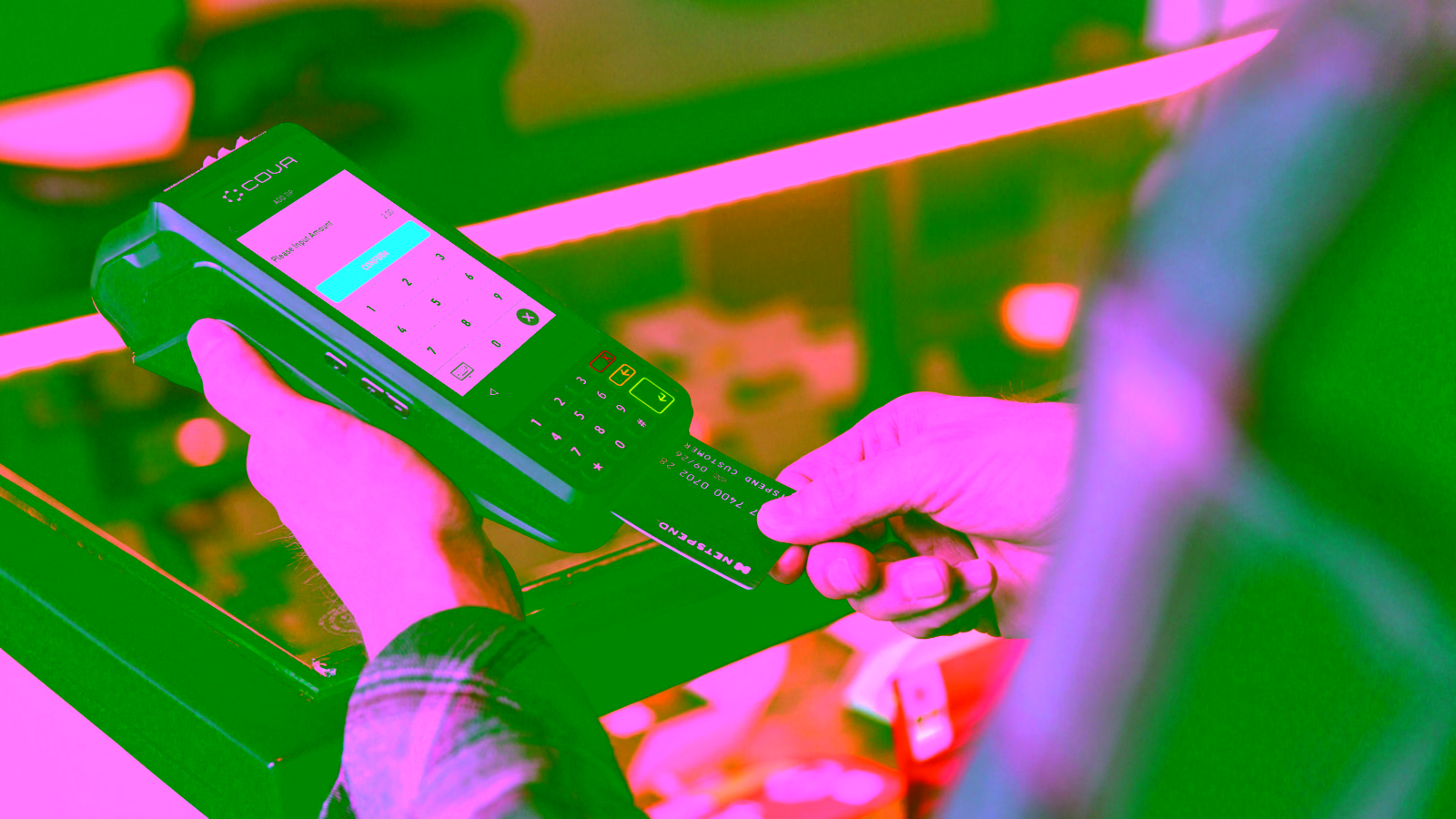 Person using credit card on payment terminal at checkout