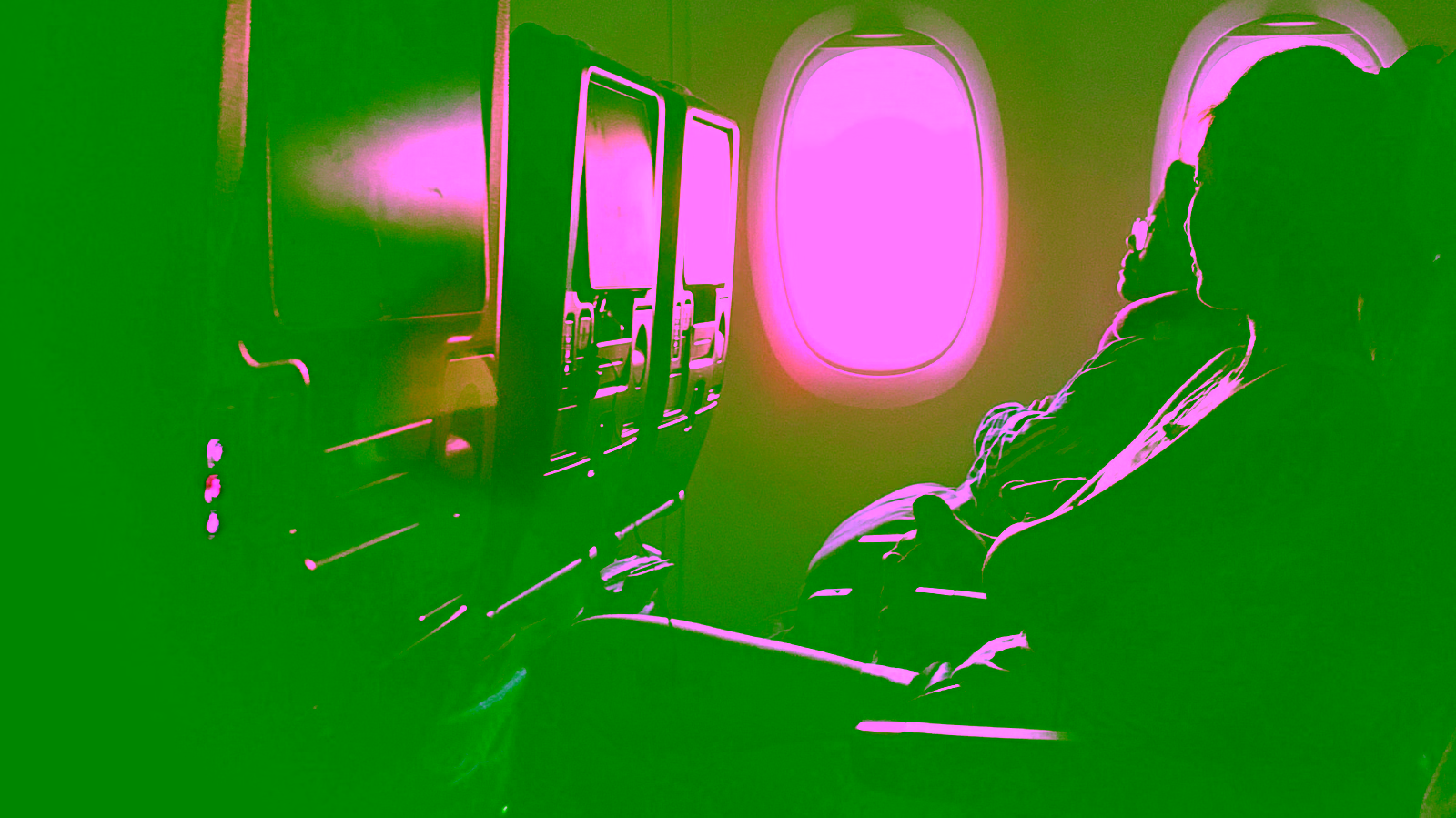Passenger in airplane cabin with sunlight