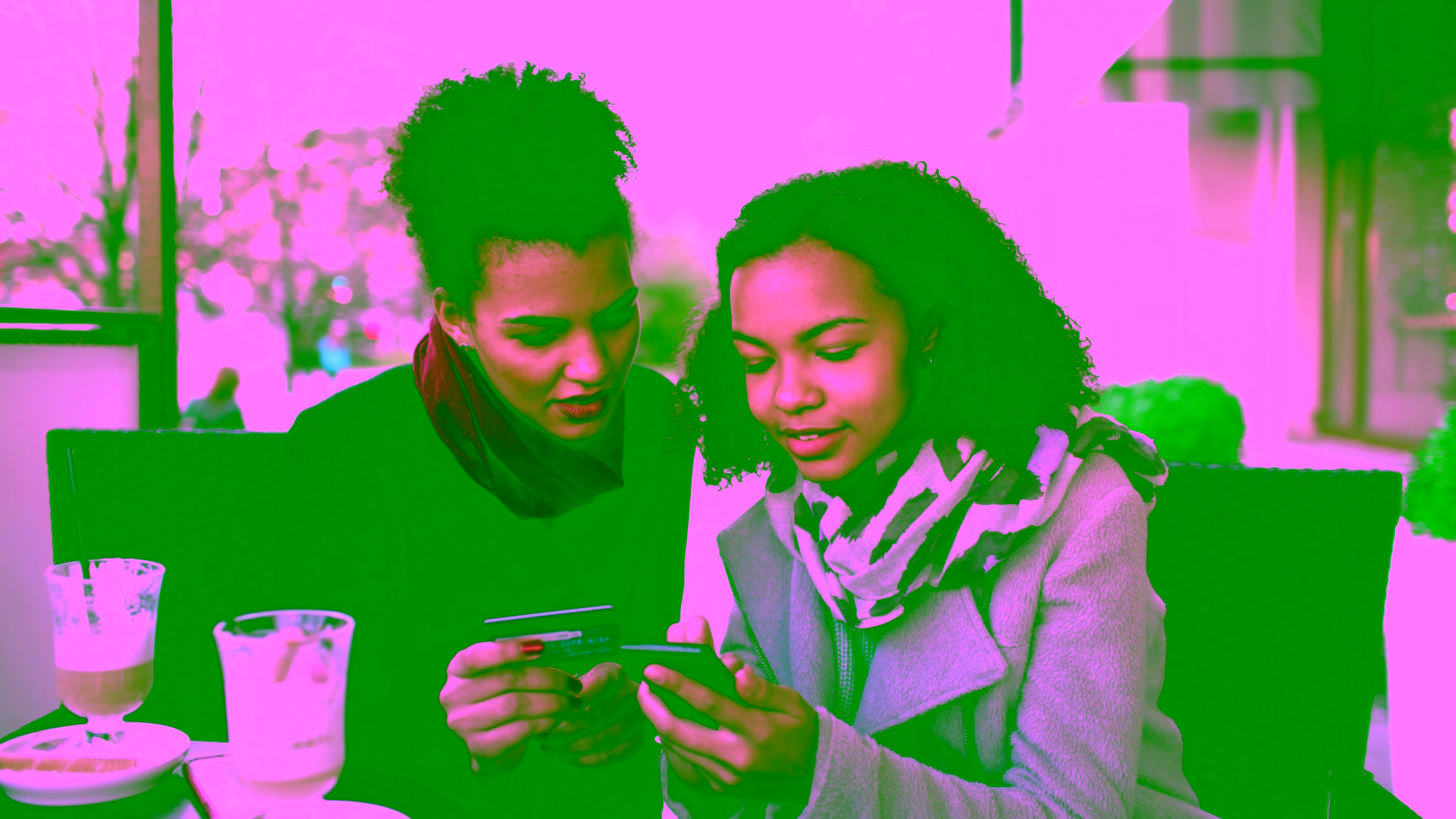 Women reviewing credit card together