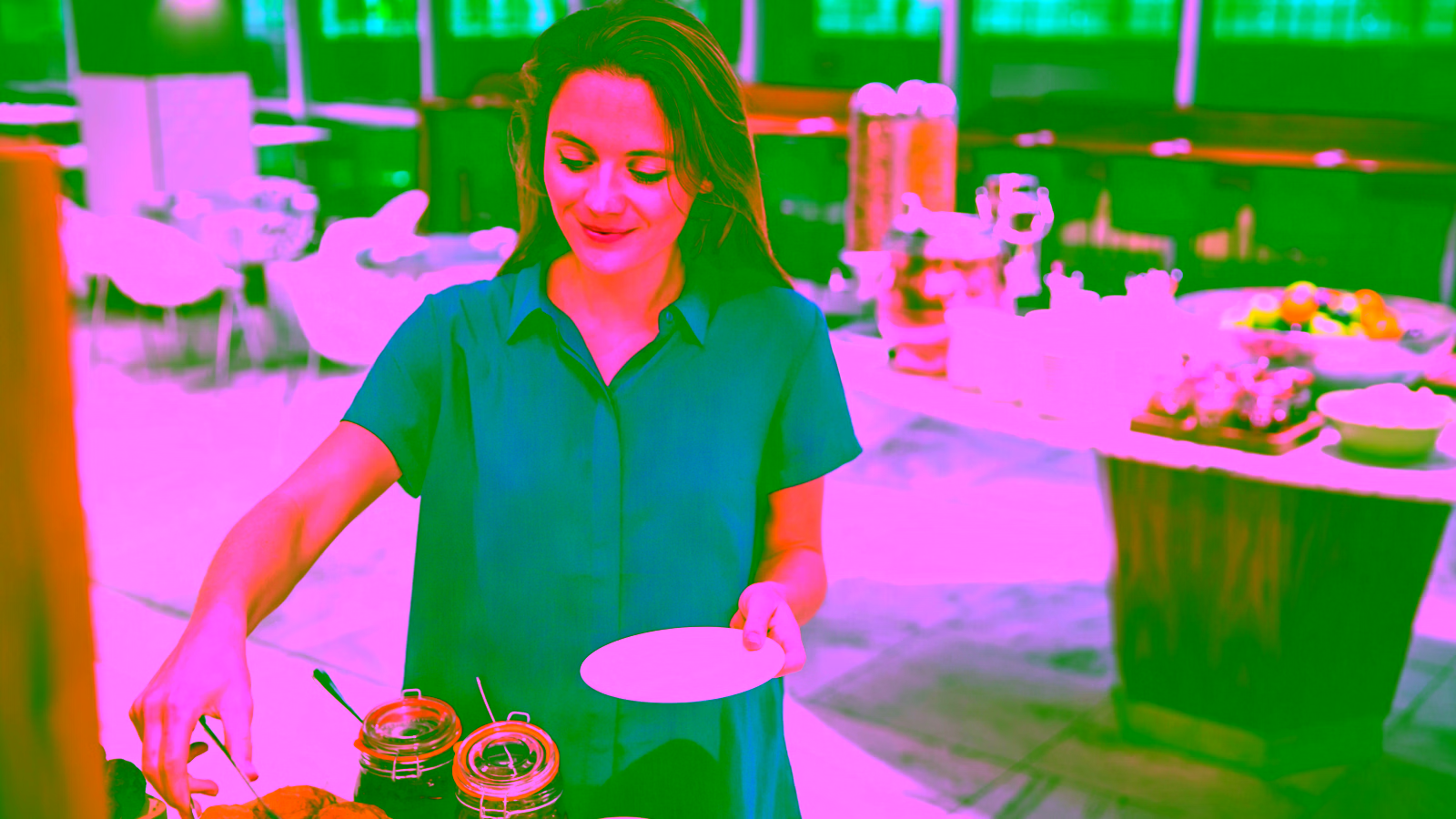 Woman selecting food at premium airport lounge buffet