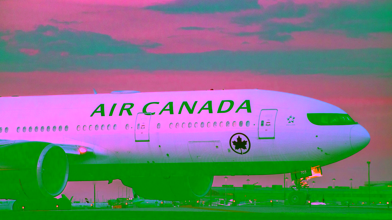 Air Canada airplane at airport during sunset