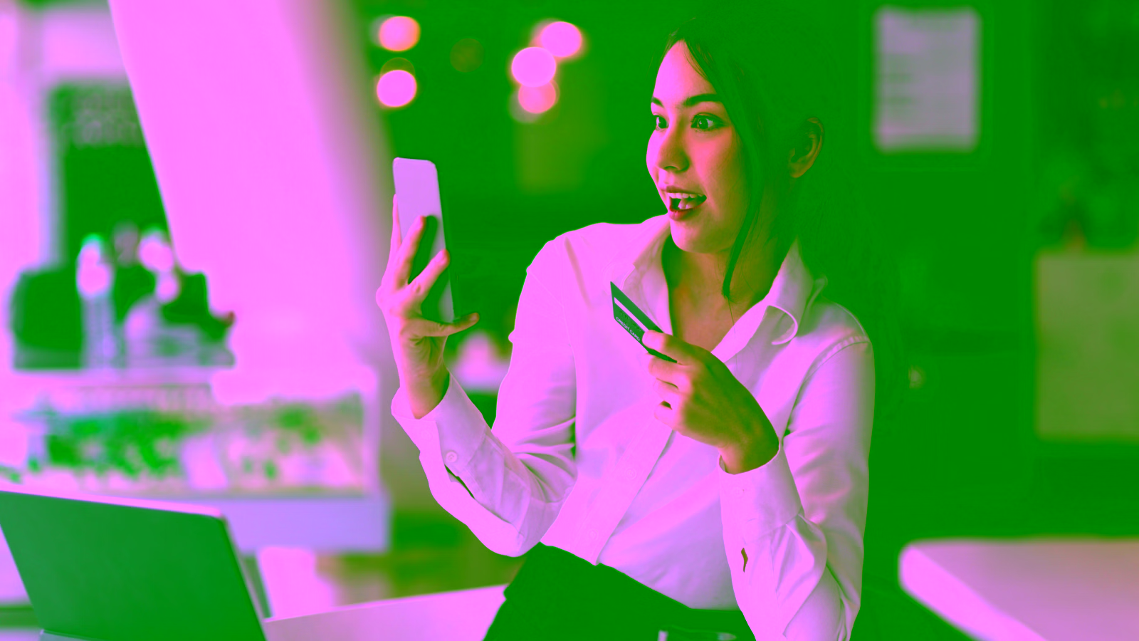 Woman holding smartphone and credit card