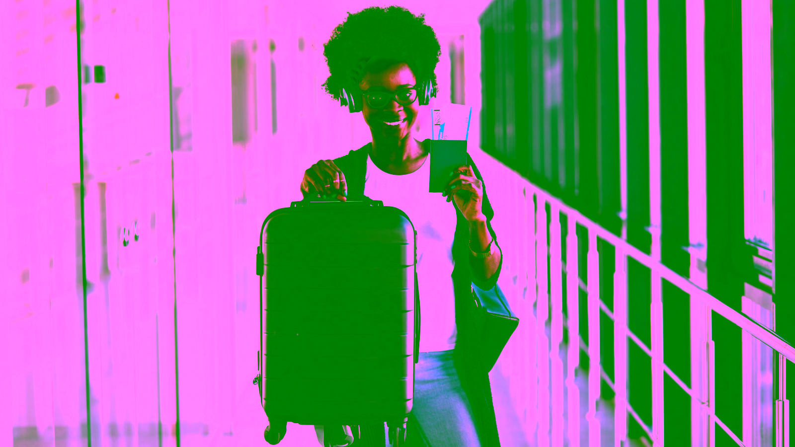 Happy traveler at airport with suitcase and passport
