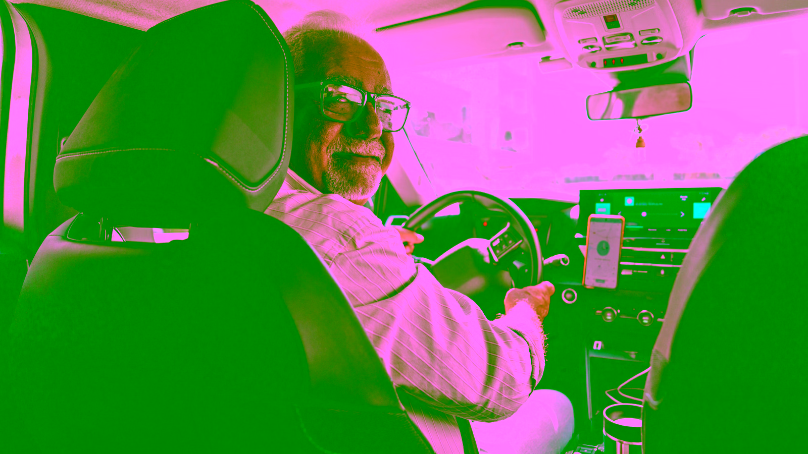 Uber driver in car with rideshare app