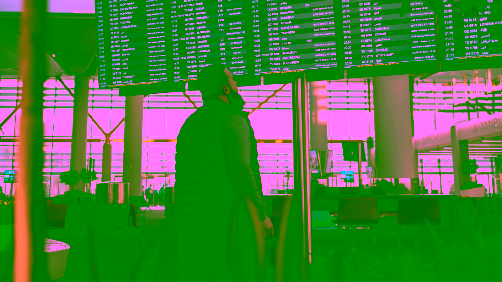 Traveler checking airport departure board at terminal