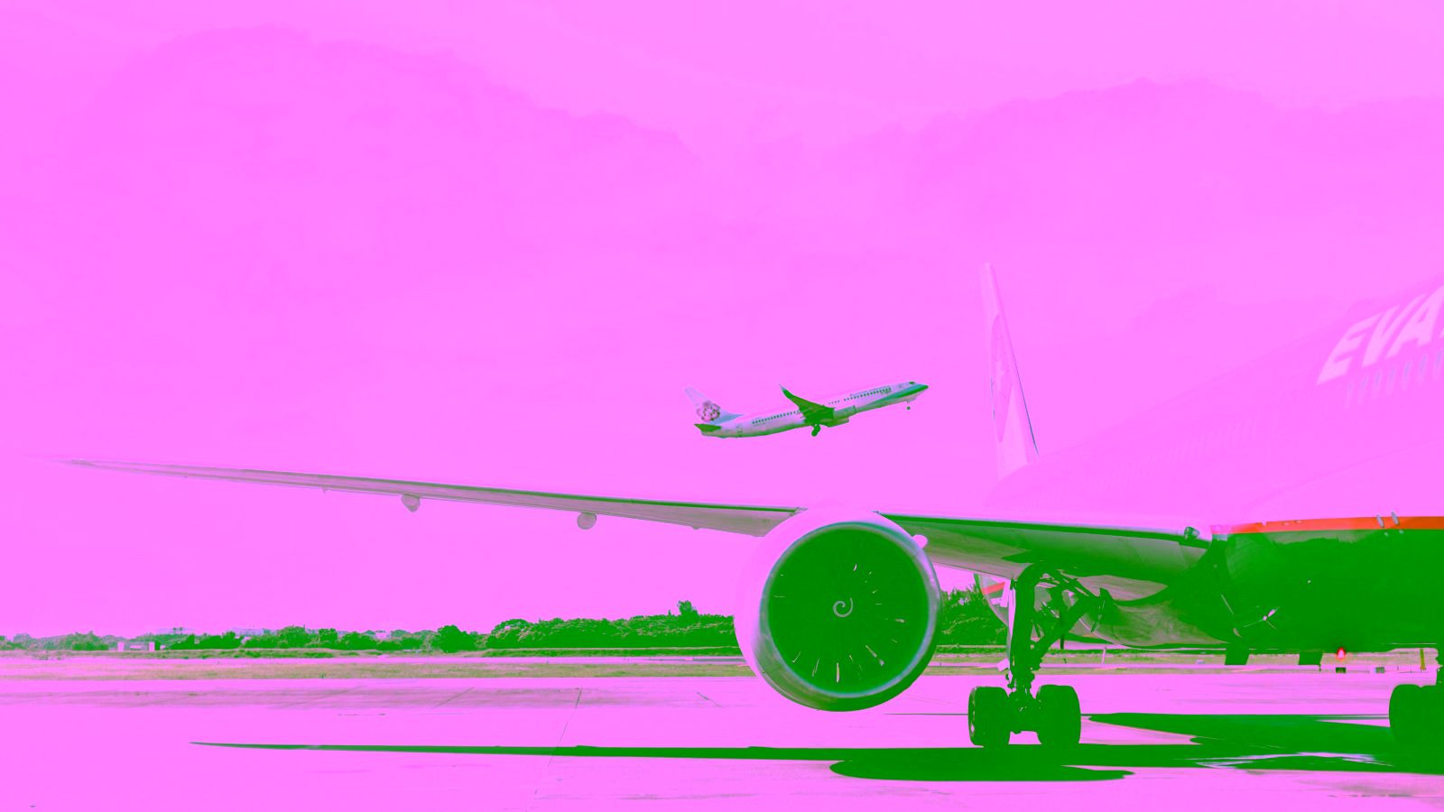 EVA Air aircraft at airport with plane taking off