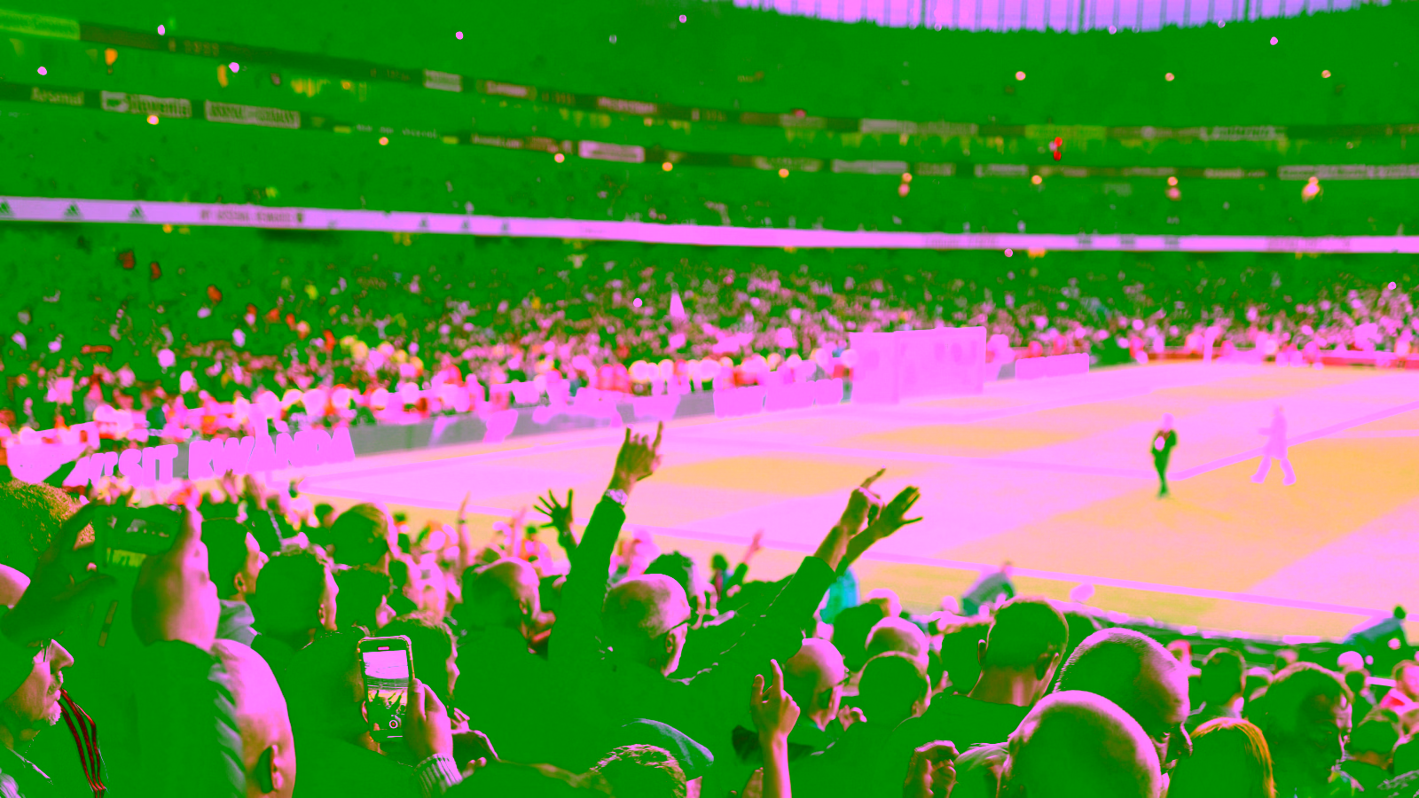 Fans cheering at a football stadium during a match
