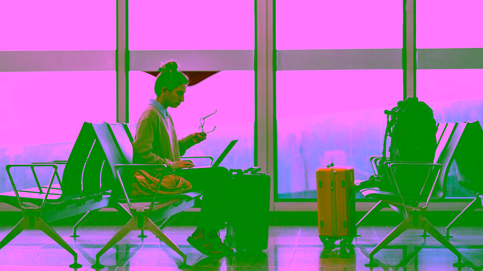 Traveler working on laptop at airport gate