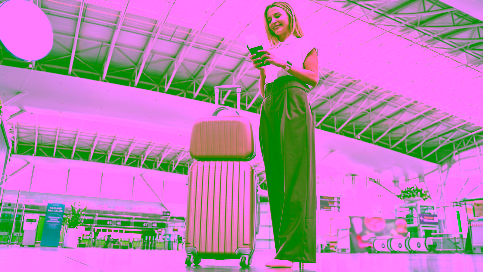Woman with luggage at the airport terminal.