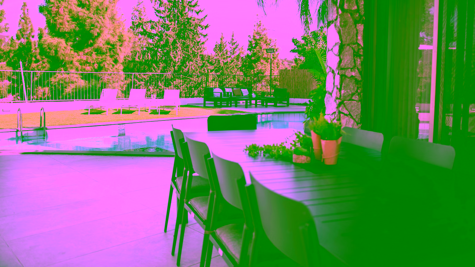 Poolside patio with outdoor dining area and lounge seating