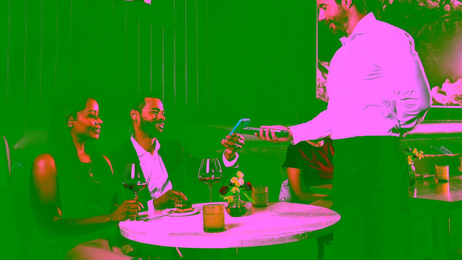 Restaurant customer paying with a smartphone at the table