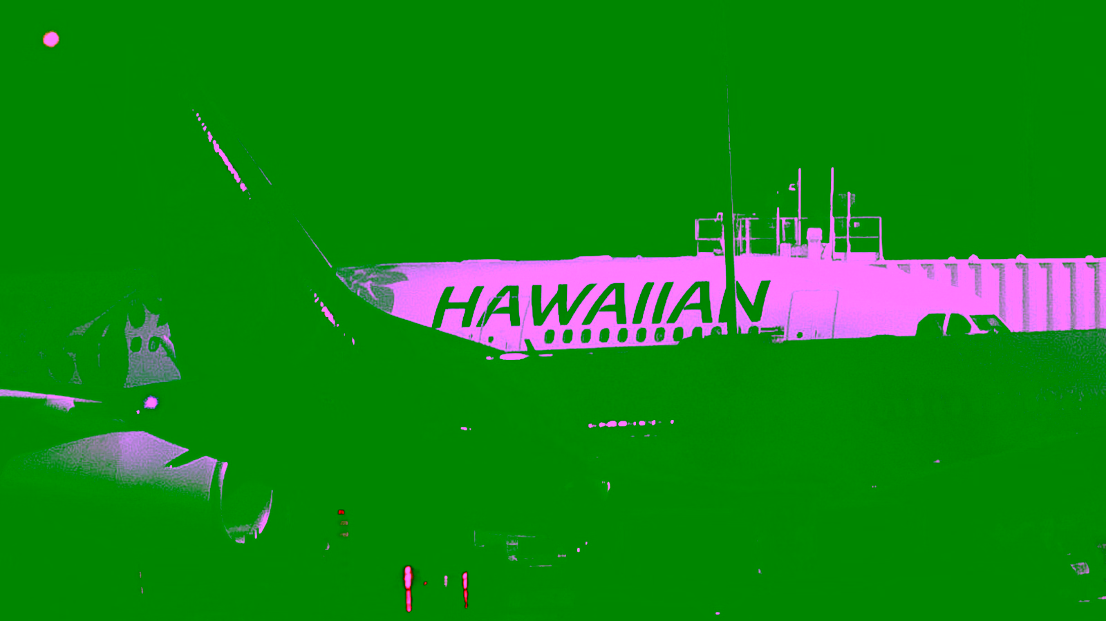 Hawaiian Airlines aircraft parked at the gate at night