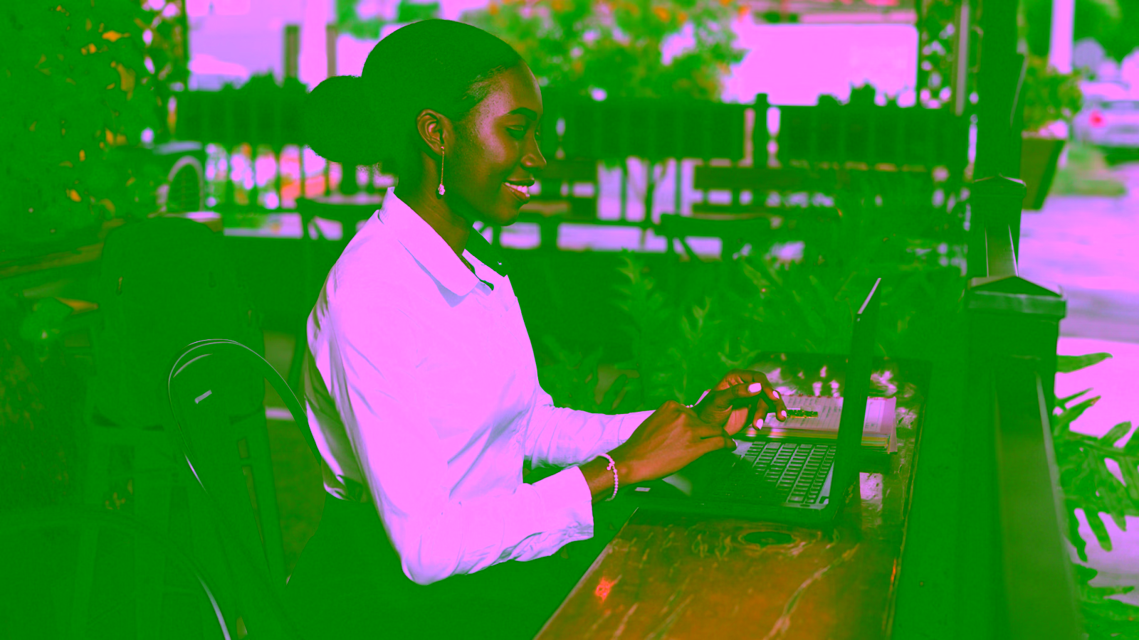 Woman working on laptop at café table