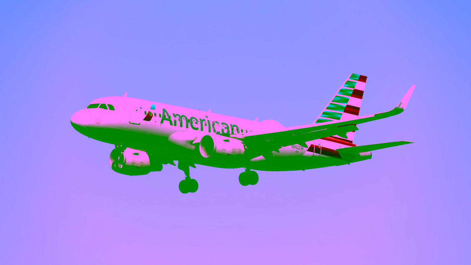 American Airlines aircraft flying against a clear blue sky