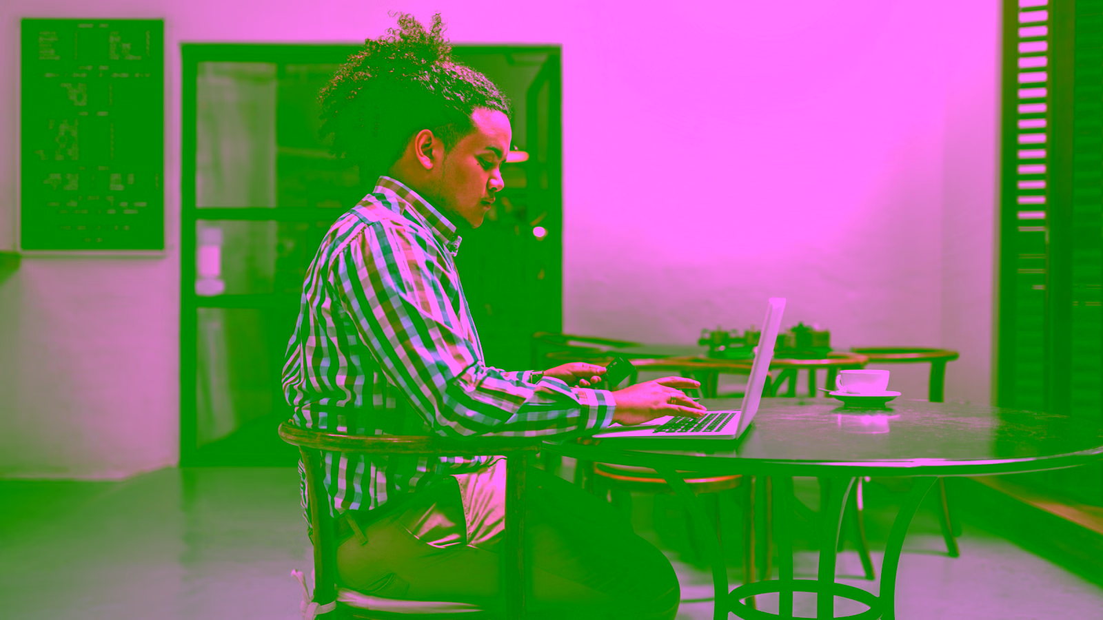 Person working on a laptop at a cafe
