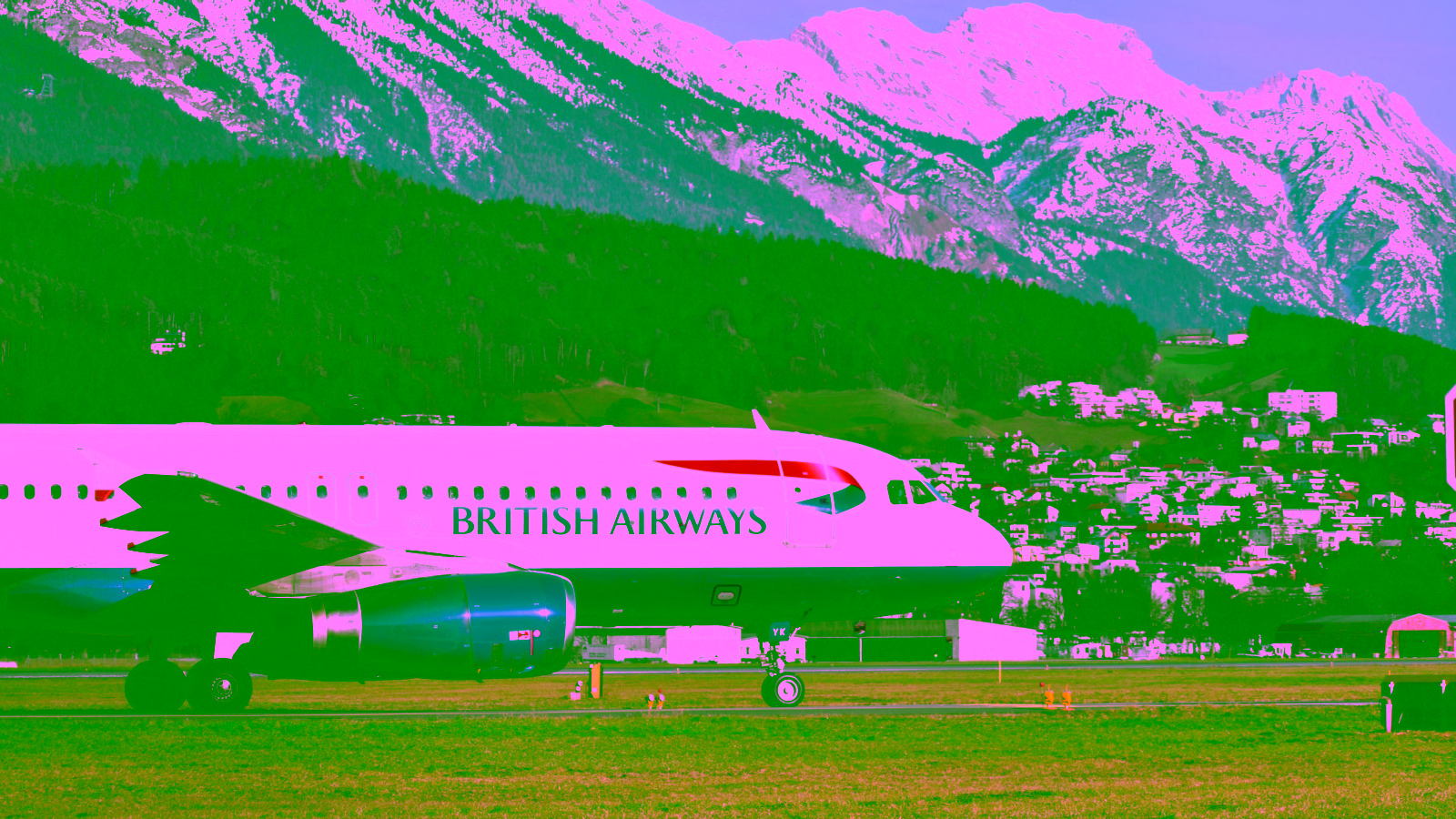 British Airways plane at an airport with snowy mountains