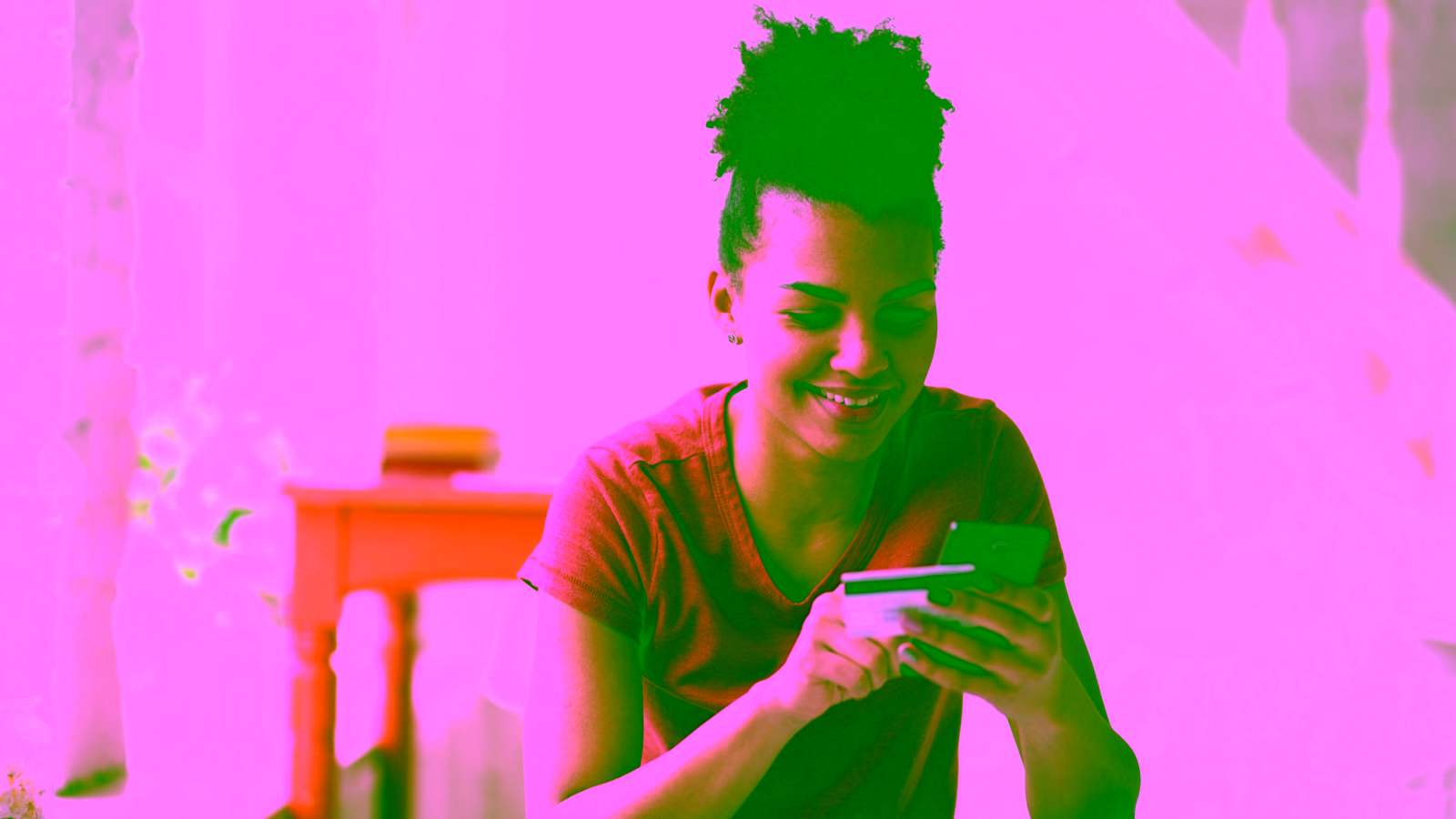 Woman using a credit card and smartphone