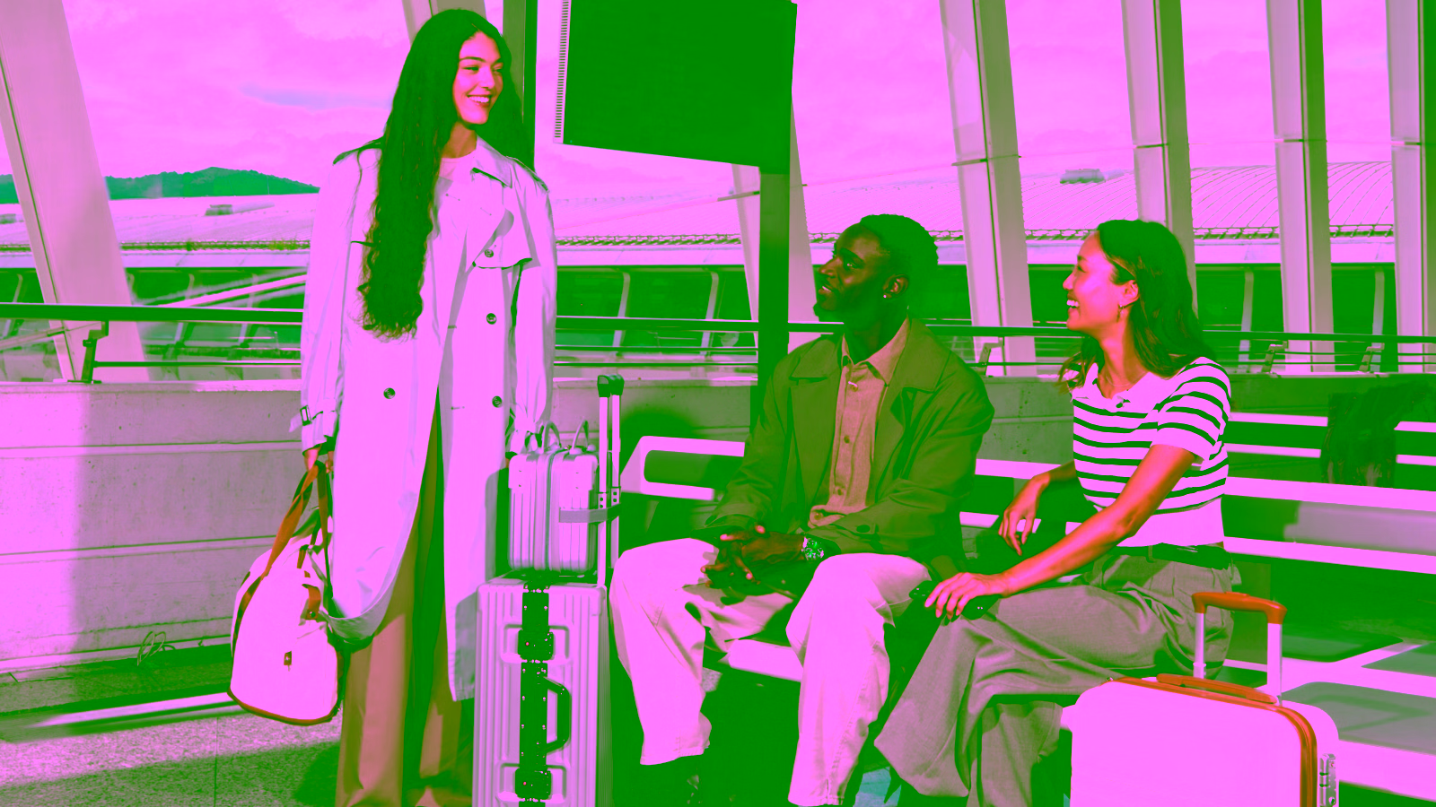 Travelers waiting at an airport with luggage