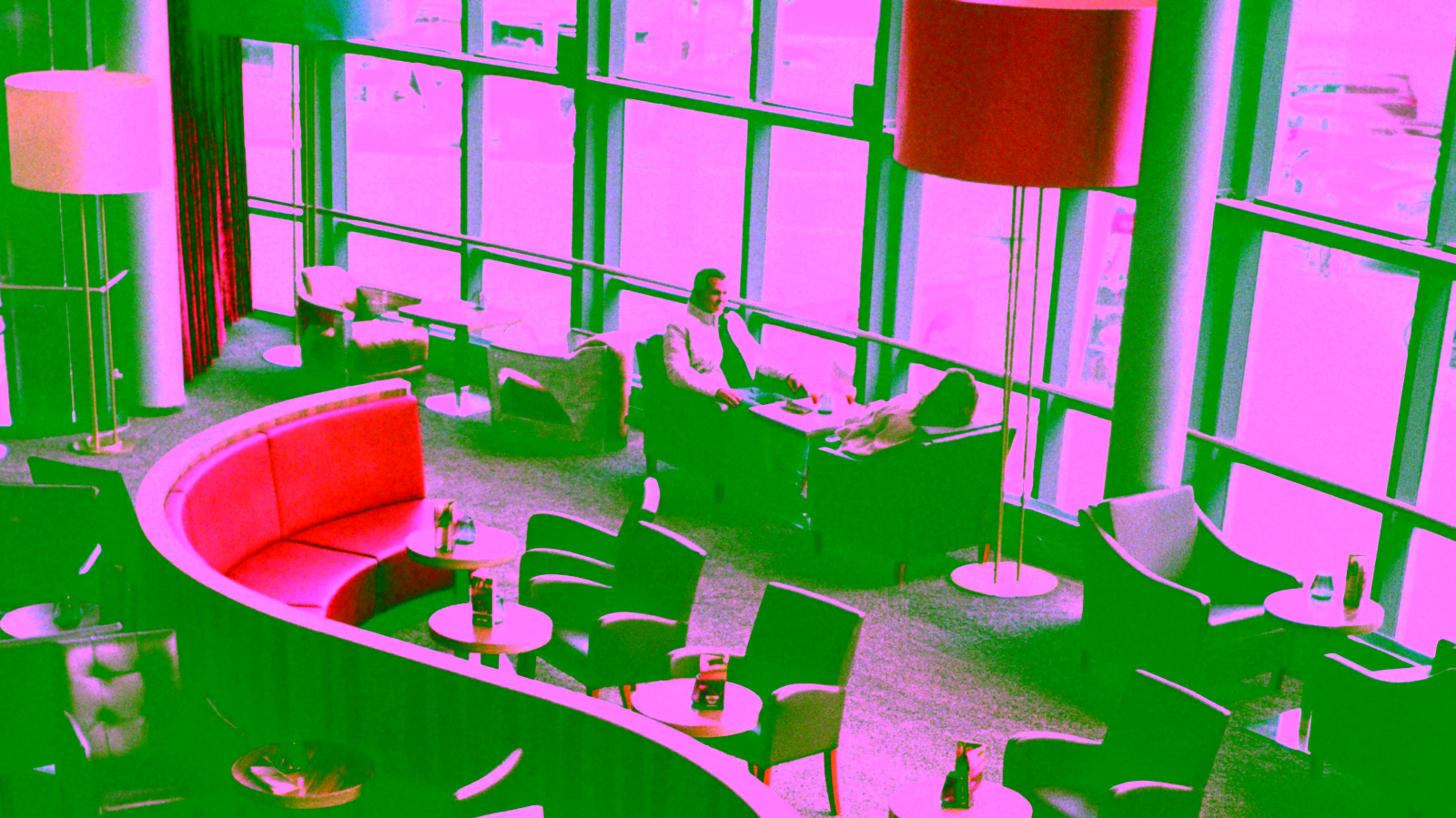 Airport lounge seating area with tables and chairs