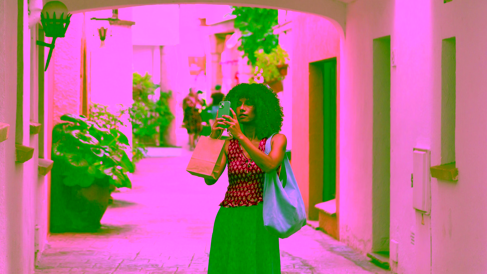 Woman taking a selfie in a charming European alleyway.