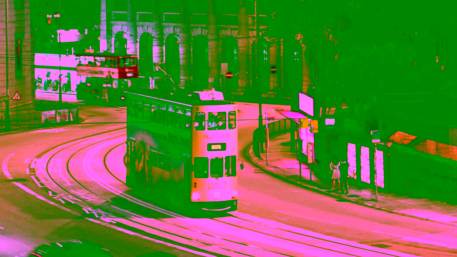 Hong Kong double-decker trams on a city street.
