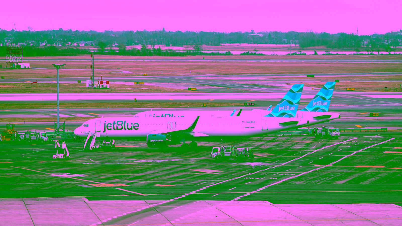 JetBlue airplanes parked at an airport terminal.