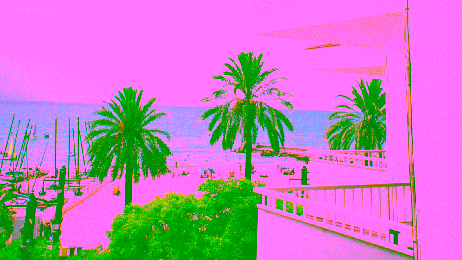 Beachfront hotel balcony overlooking a tropical beach