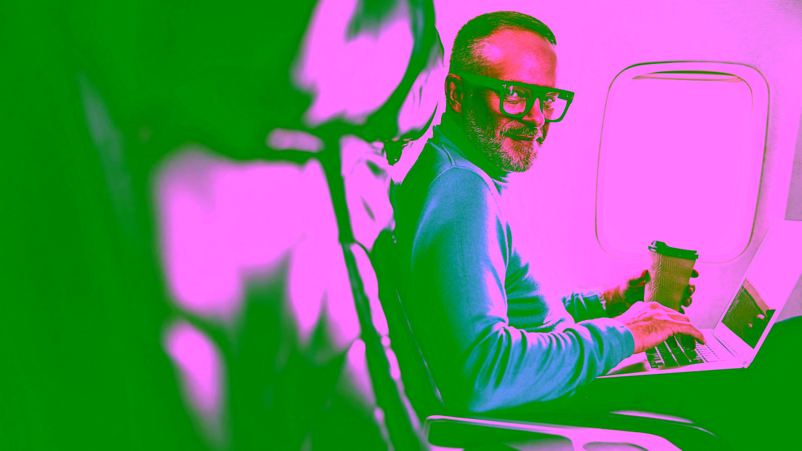 Man working on a laptop during a flight