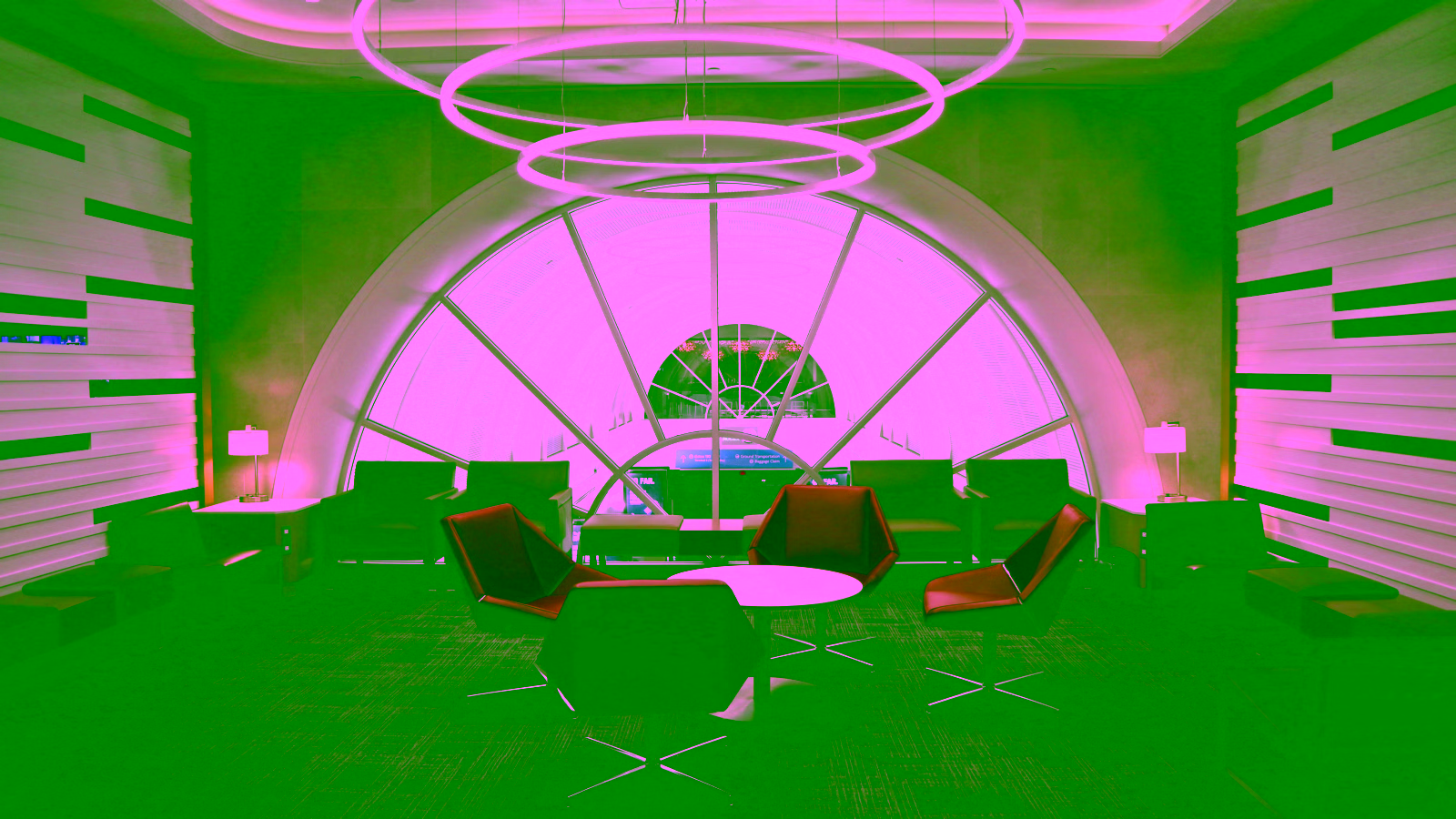 Modern lounge with red chairs and circular ceiling lights