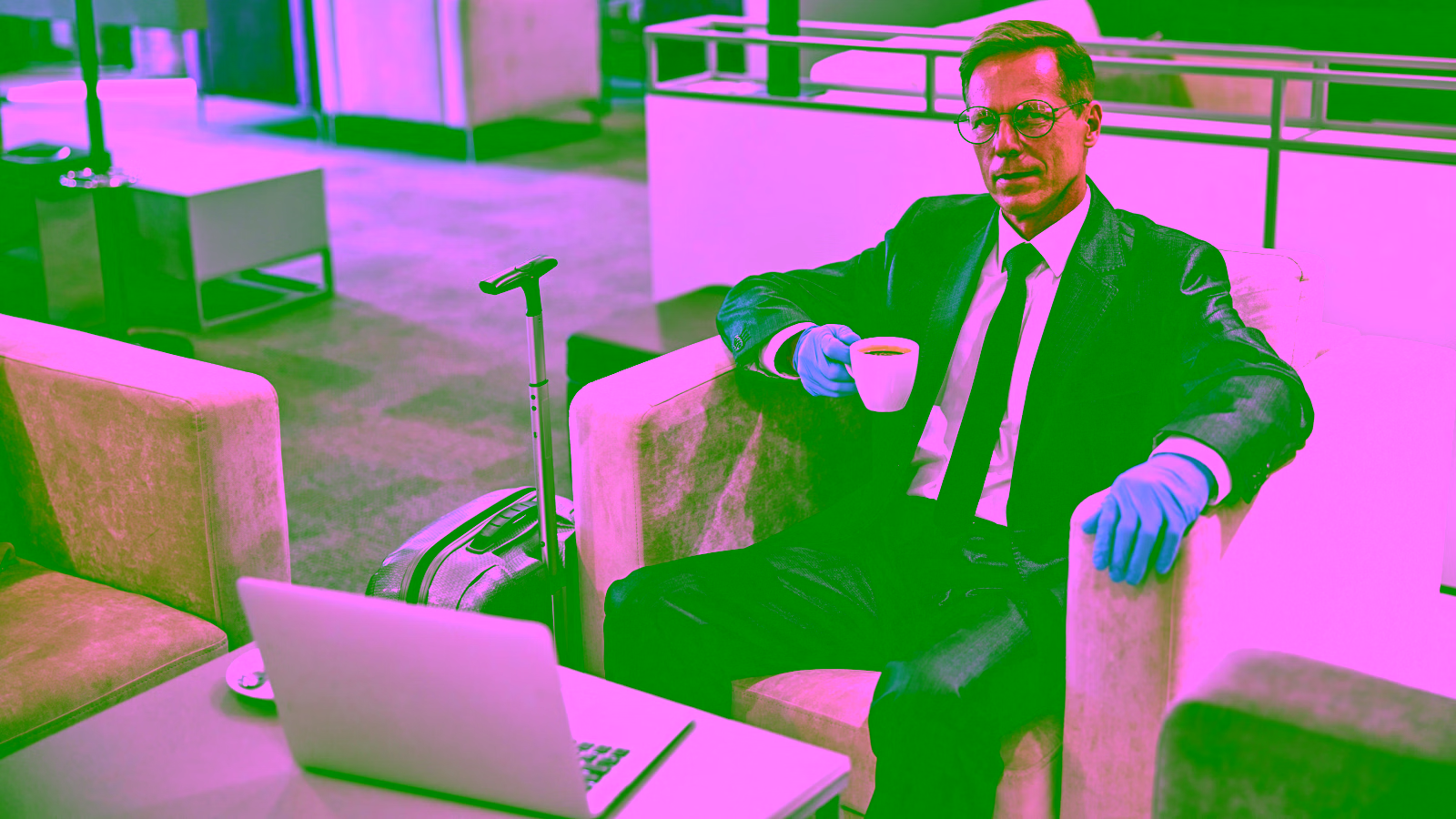 Business traveler drinking coffee in airport lounge