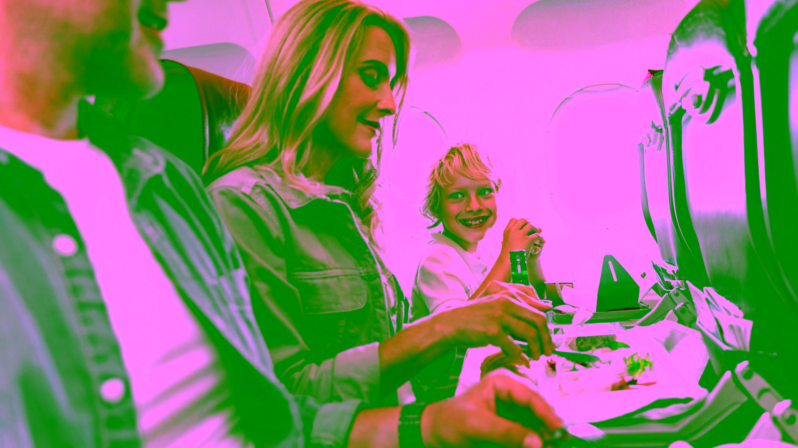Family enjoying a meal on an airplane