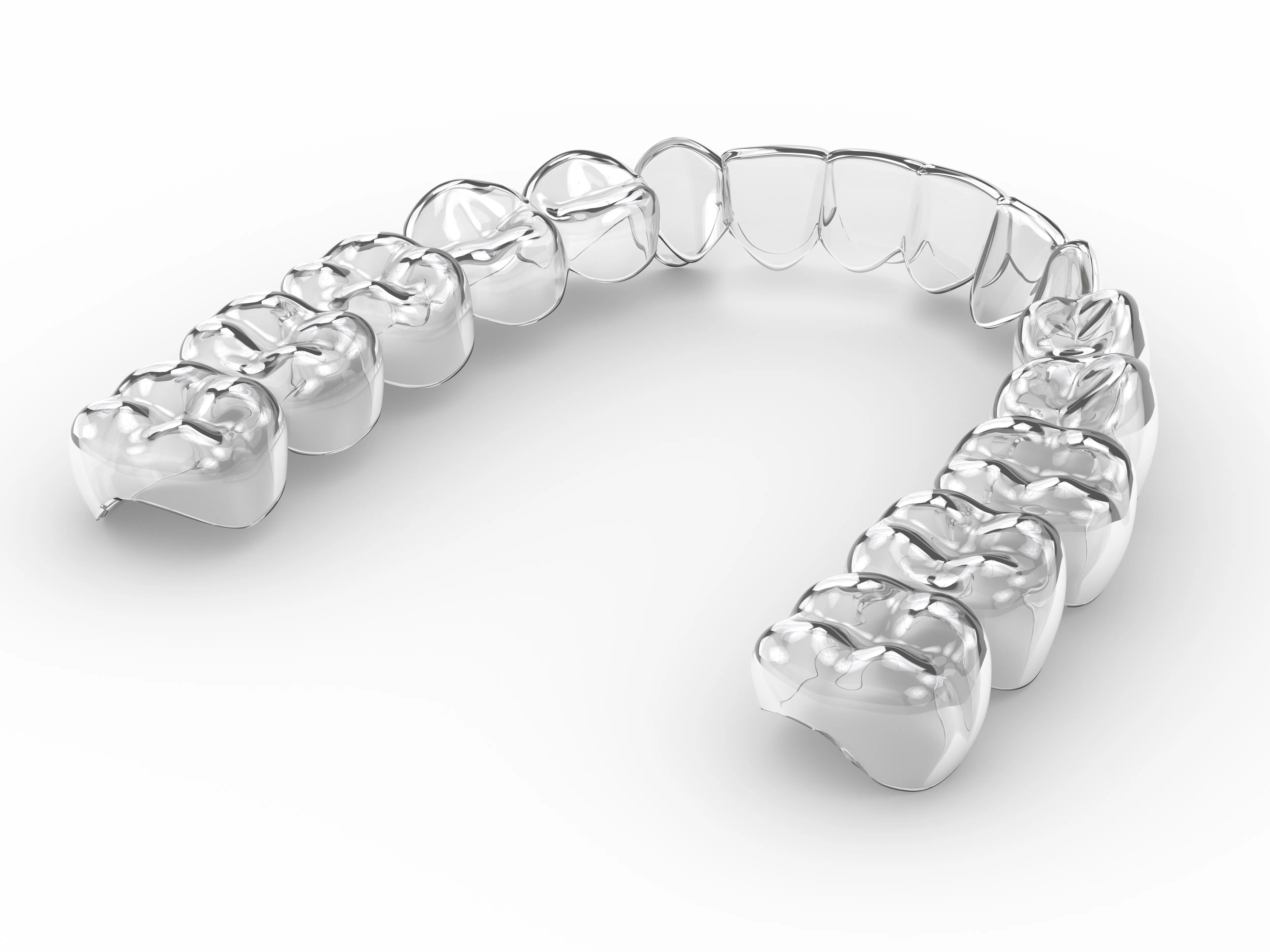 Transparent Invisalign aligner tray shaped to fit over teeth for orthodontic treatment in Alpharetta.