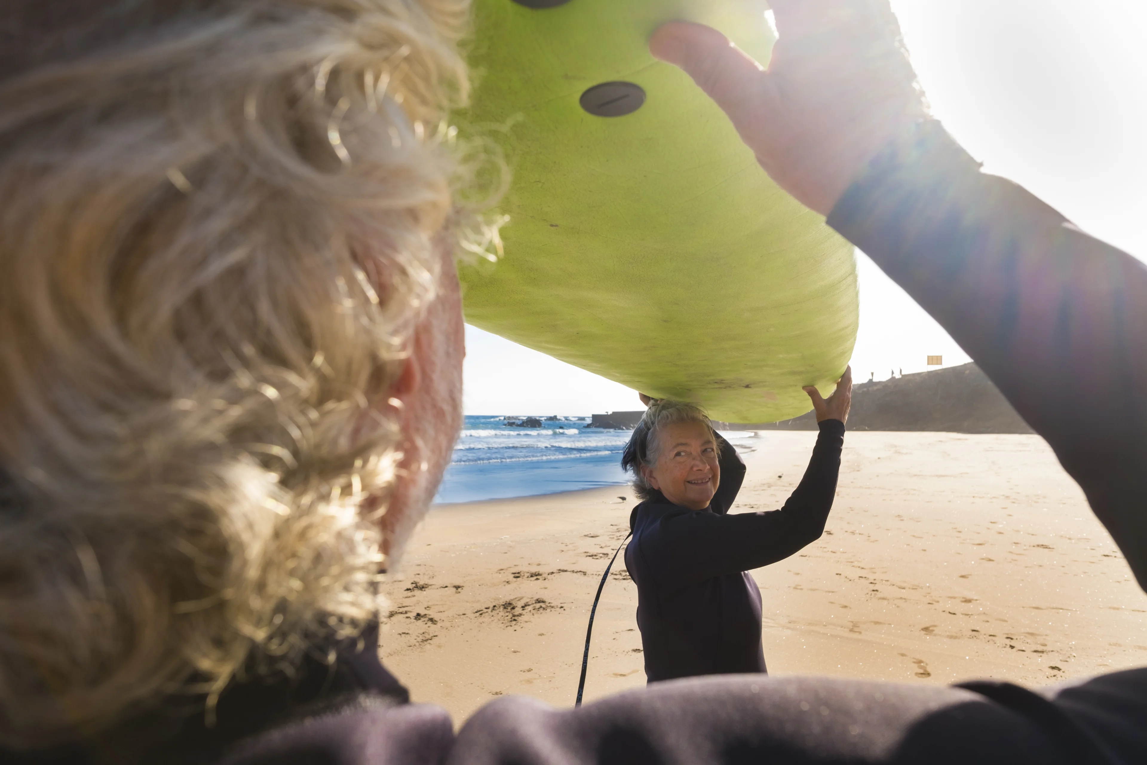 explorabout couple seniors surf beach