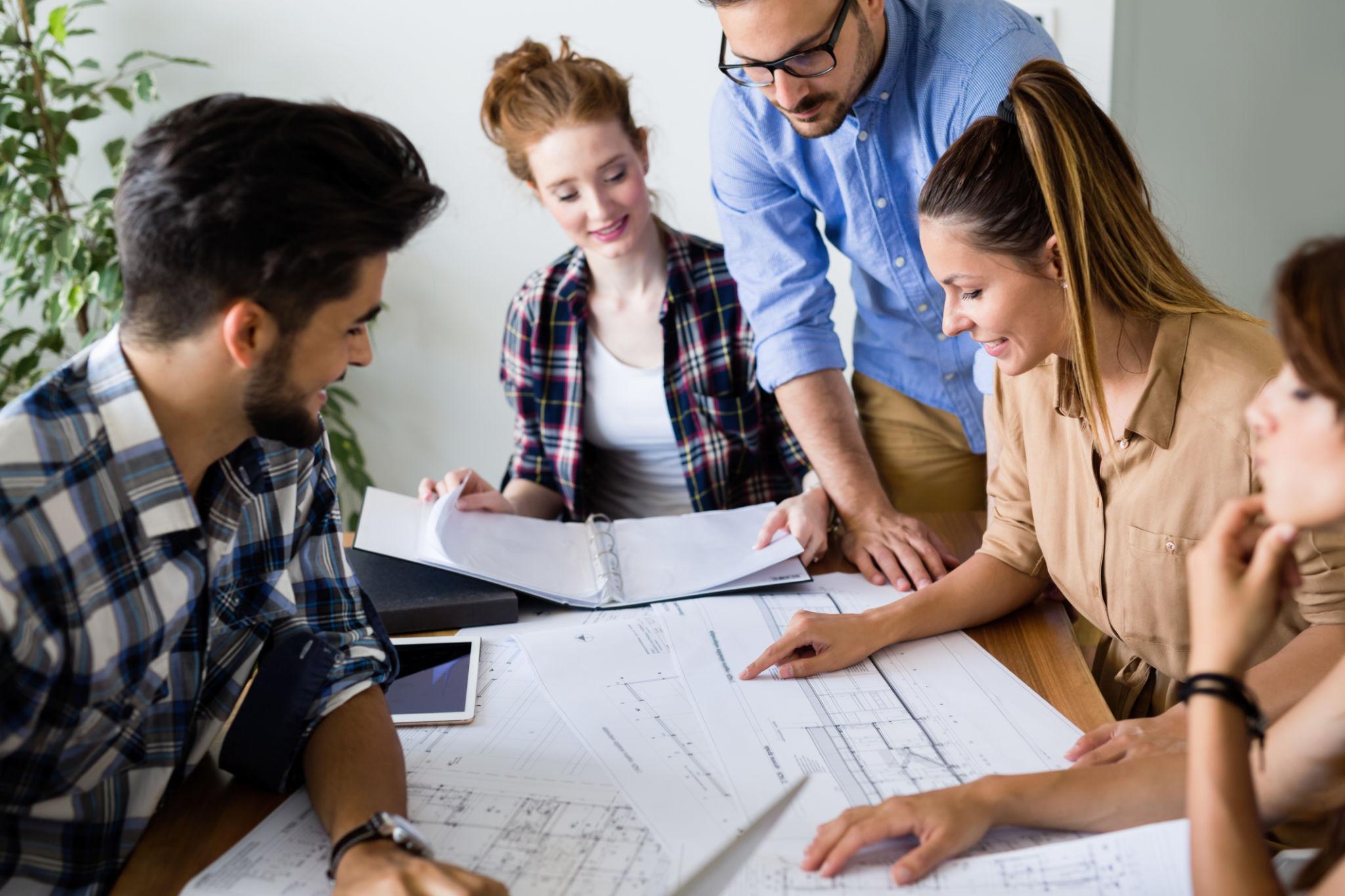 Group of architects and designers working and collaborating on project