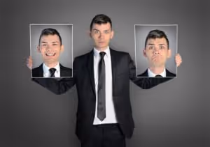 Business Man Holds Face of Him Smiling and Face of Him Frowning