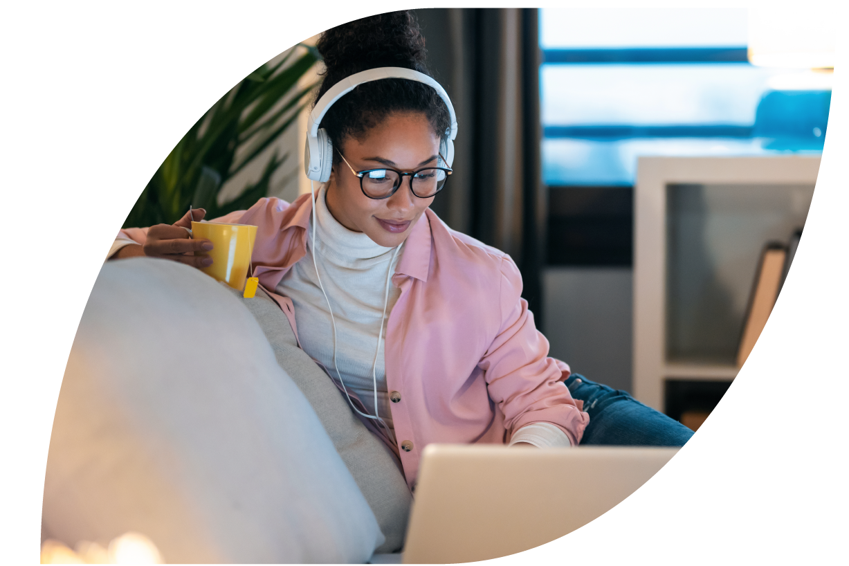 Image of woman with headphones and her laptop
