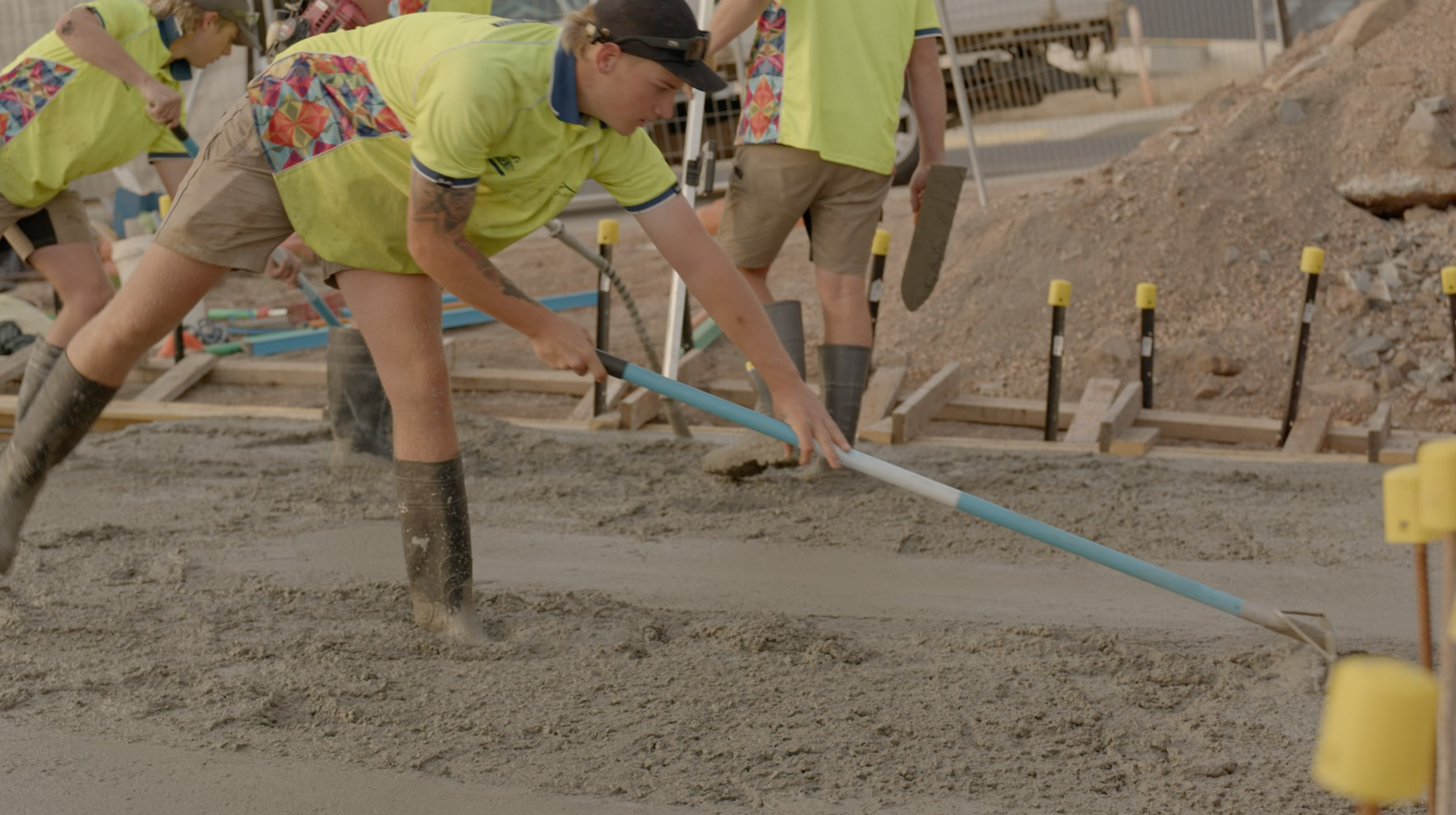 A Group of people flattening concrete.