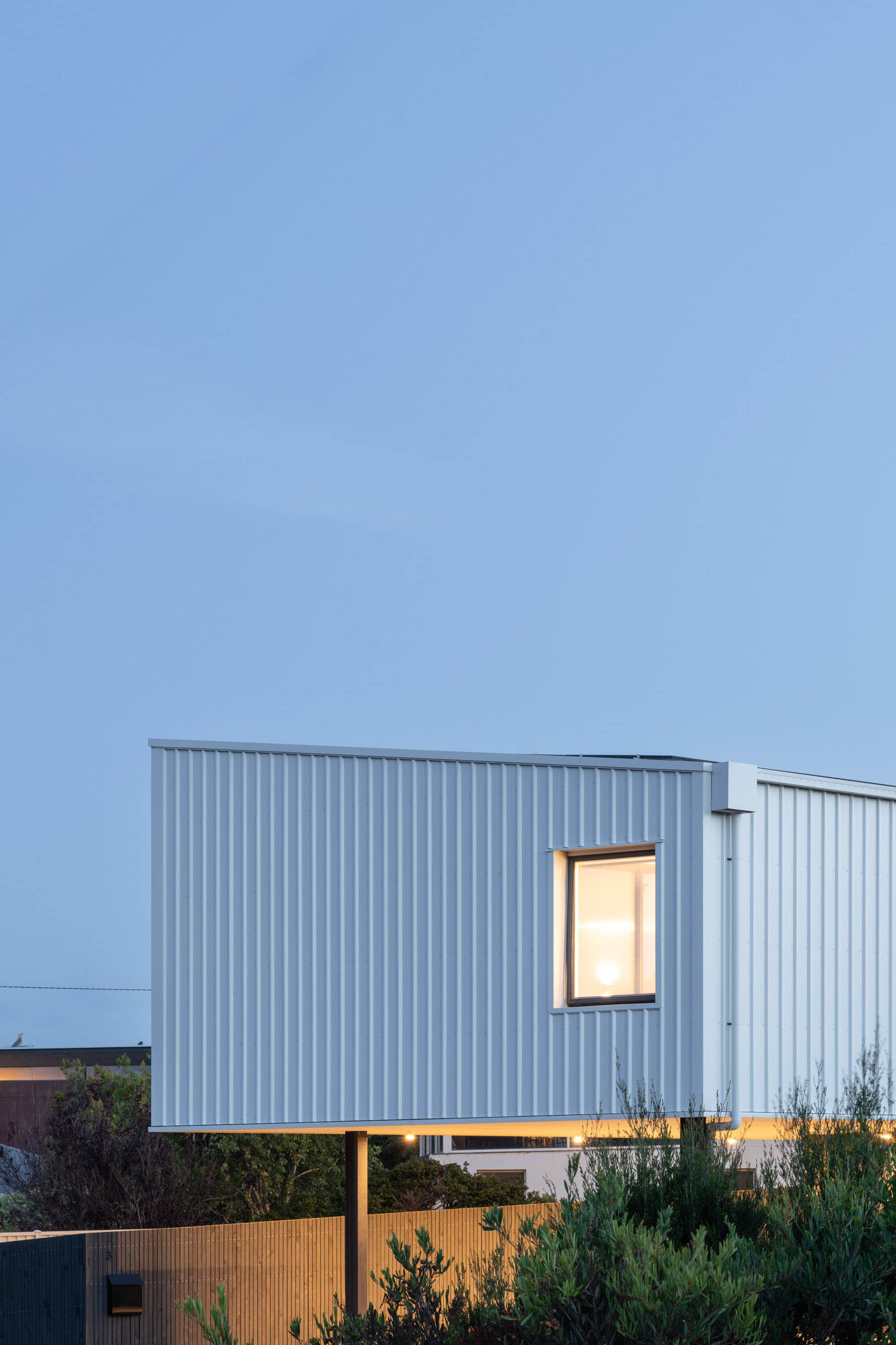 External image of a white coloured house with large windows.