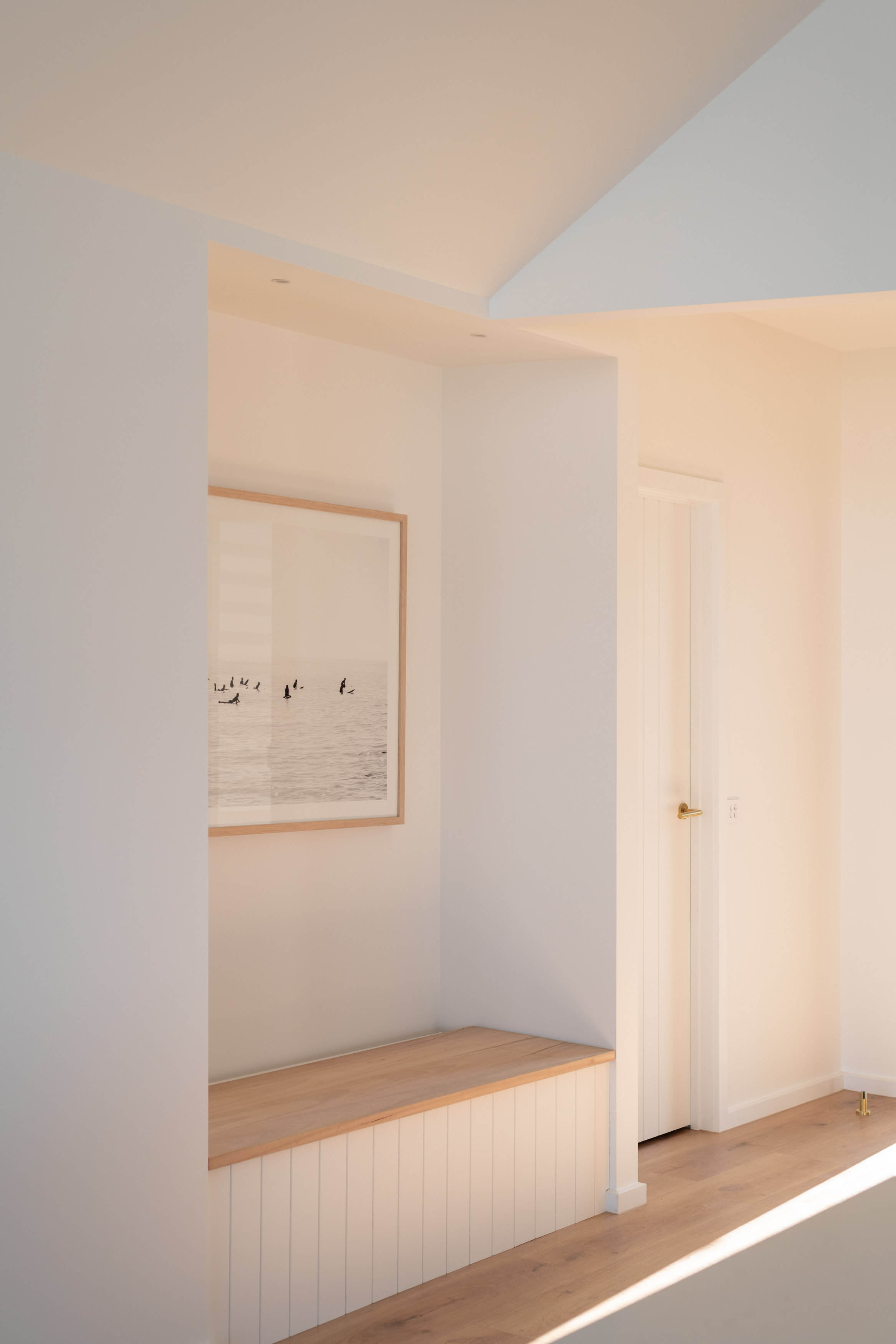 A nice small sitting area with a nice painting sitting in the corner.