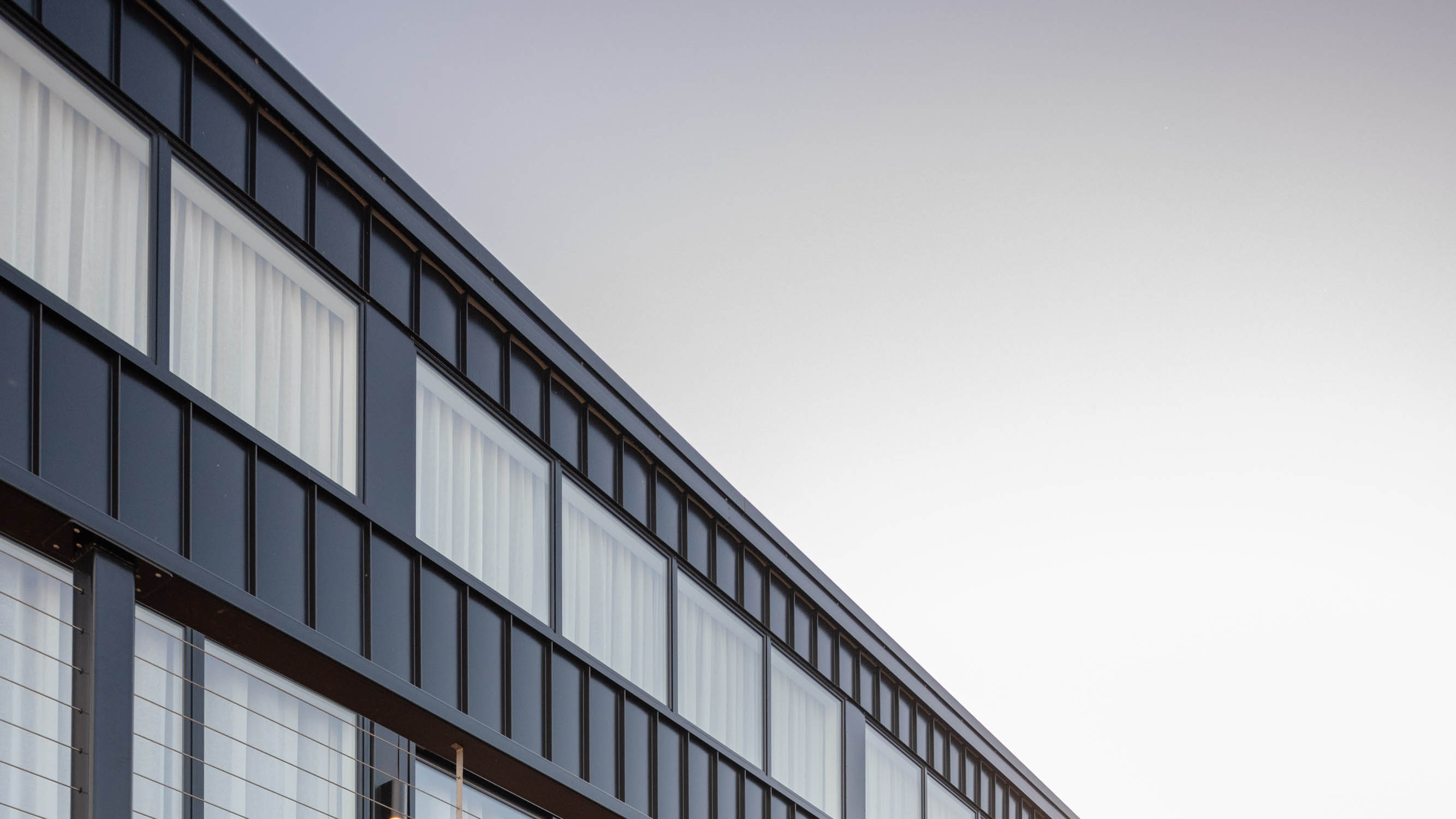 A House with an orange wood deck.