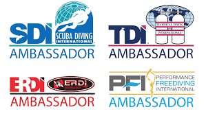 Logos de cinq ambassadeurs d'organisations de plongée sous-marine : SDI, TDI, ERDI, PFI, avec les mots 'AMBASSADOR' ou 'AMBASSADEUR'.