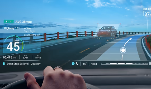 View from inside a car showing a digital dashboard with speed 45 mph, navigation instructions to turn right, and a highlighted car on the road ahead.