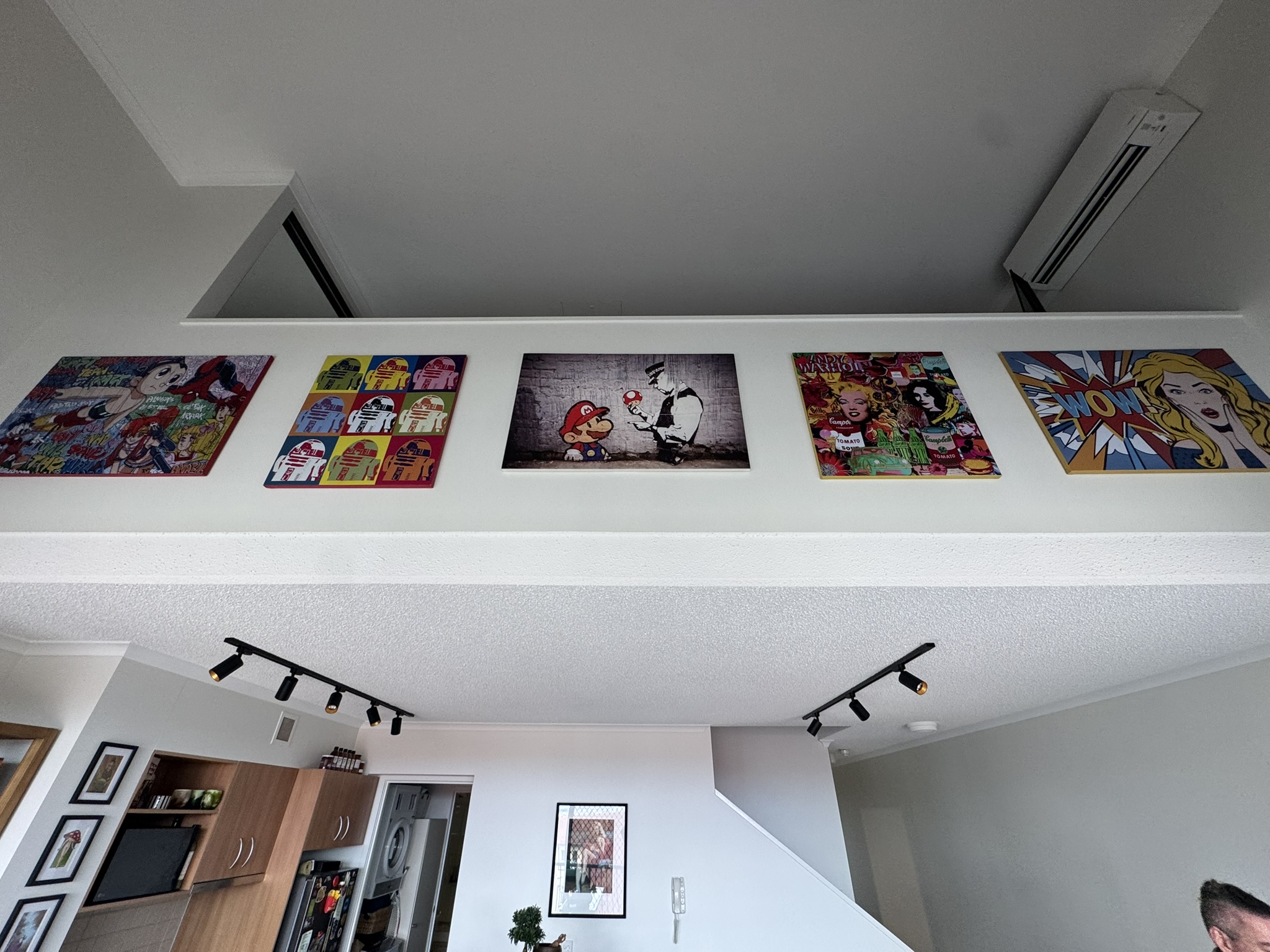 How full home art installations are planned and executed in Brisbane's luxury homes — from initial layout to final hang. By James Woods.