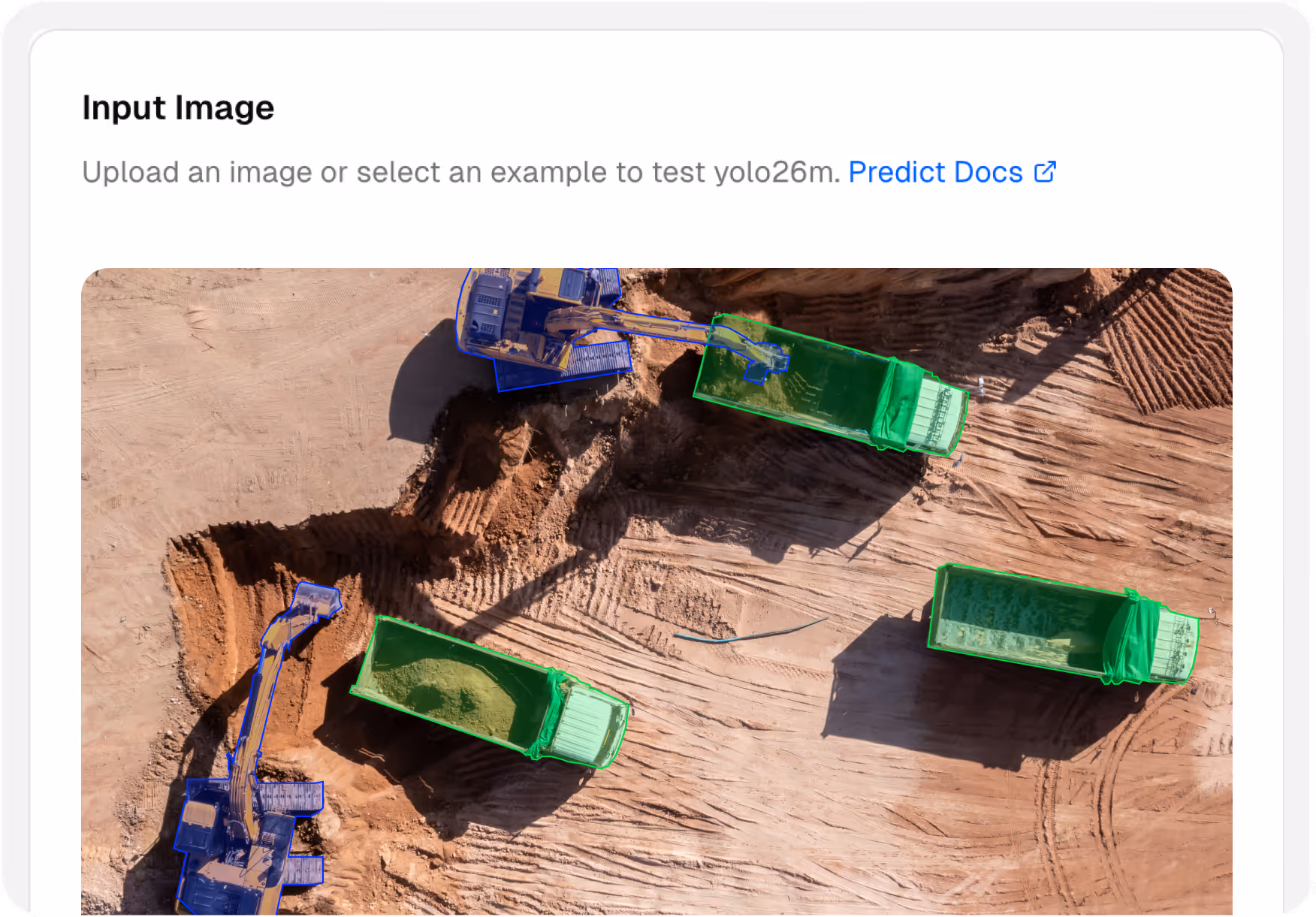 Aerial view of excavation site with two excavators loading soil into three dump trucks, all vehicles outlined in blue and green for object detection.