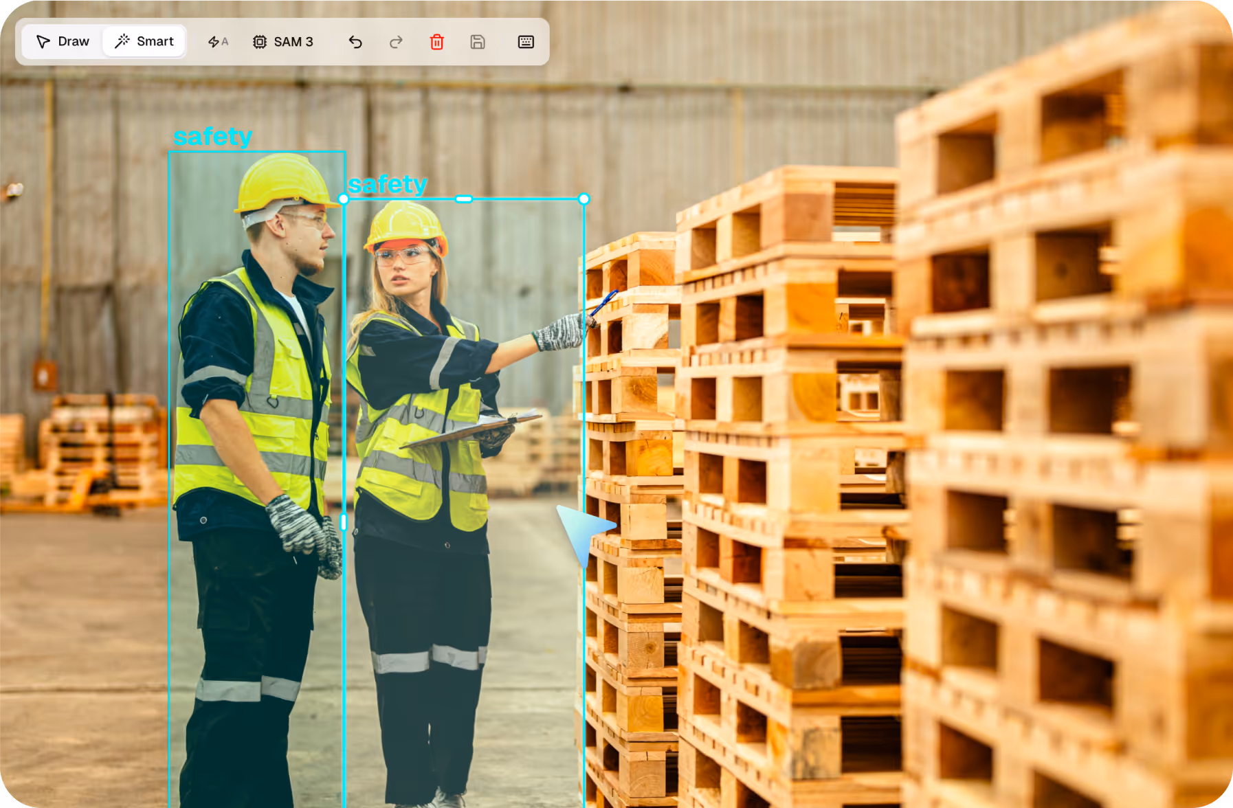 Two warehouse workers wearing yellow safety vests and helmets inspecting stacked wooden pallets.